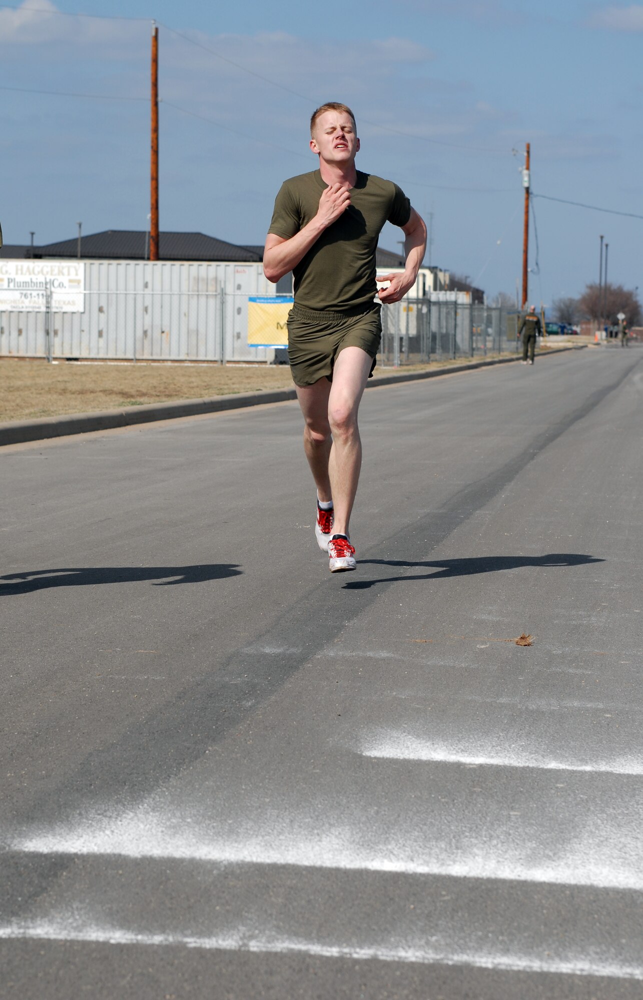 Lance Cpl. Ryan Ryan Kunzmann pushes himself across the finish line of the 5K road race during the 17th Training Wing Sports Day on Feb. 12. Goodfellow AFB, Texas took the day to hold multiple sporting events, including volleyball, tennis, and dodge ball, with each unit competing for commander’s cup points.  (U.S. Air Force photo/Master Sgt. Randy Mallard)