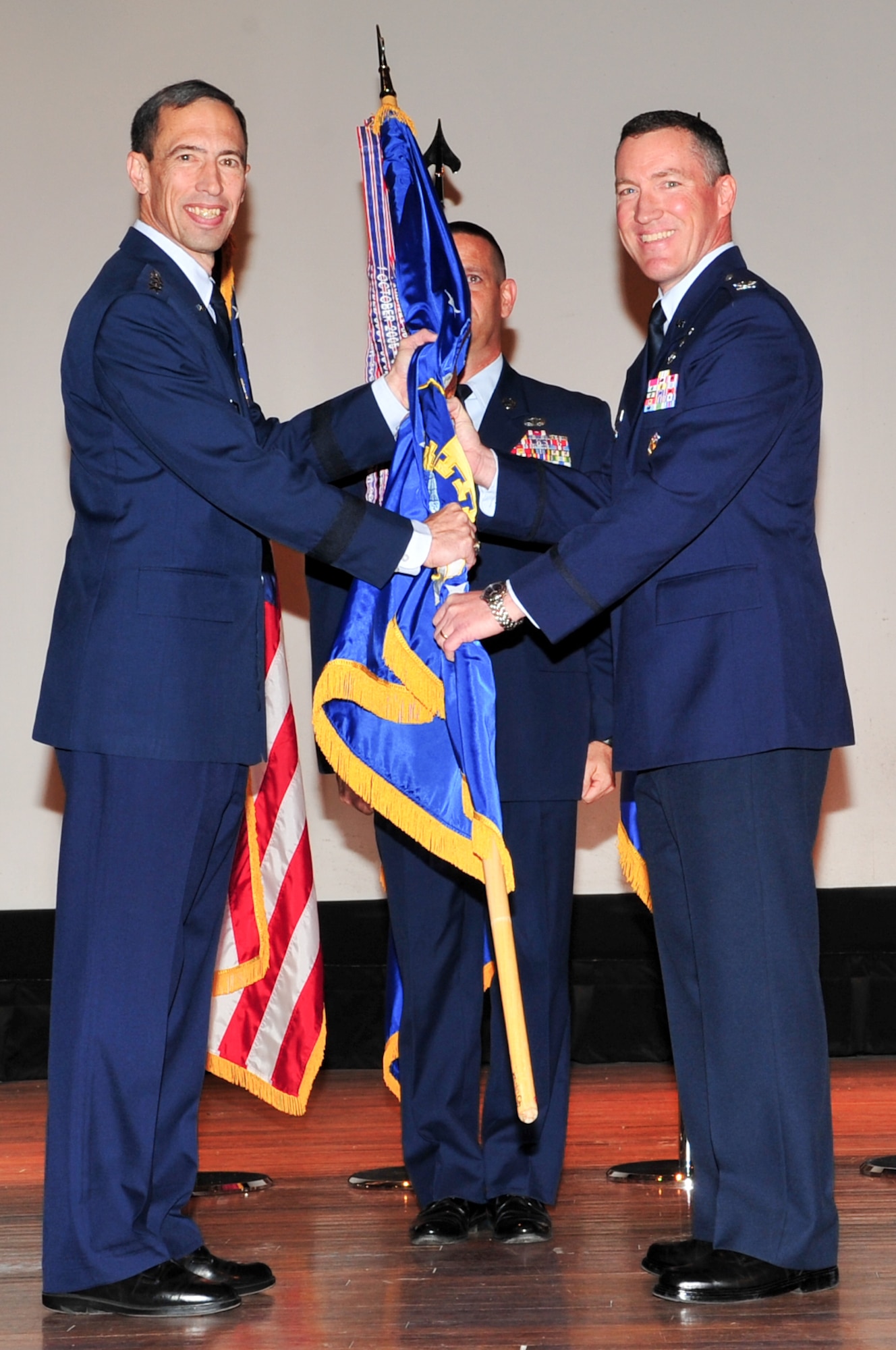 45th Space Wing Commander Col. Ed Wilson accepts the guidon from 14th Air Force Commander Lt. Gen. Larry James at a Change of Command ceremony February 12 in the base theater. Colonel Wilson came to the 45th Space Wing from Kirtland Air Force Base, N.M., where he commanded the Space Development and Test Wing. (U.S. Air Force photo/Jennifer Macklin)
