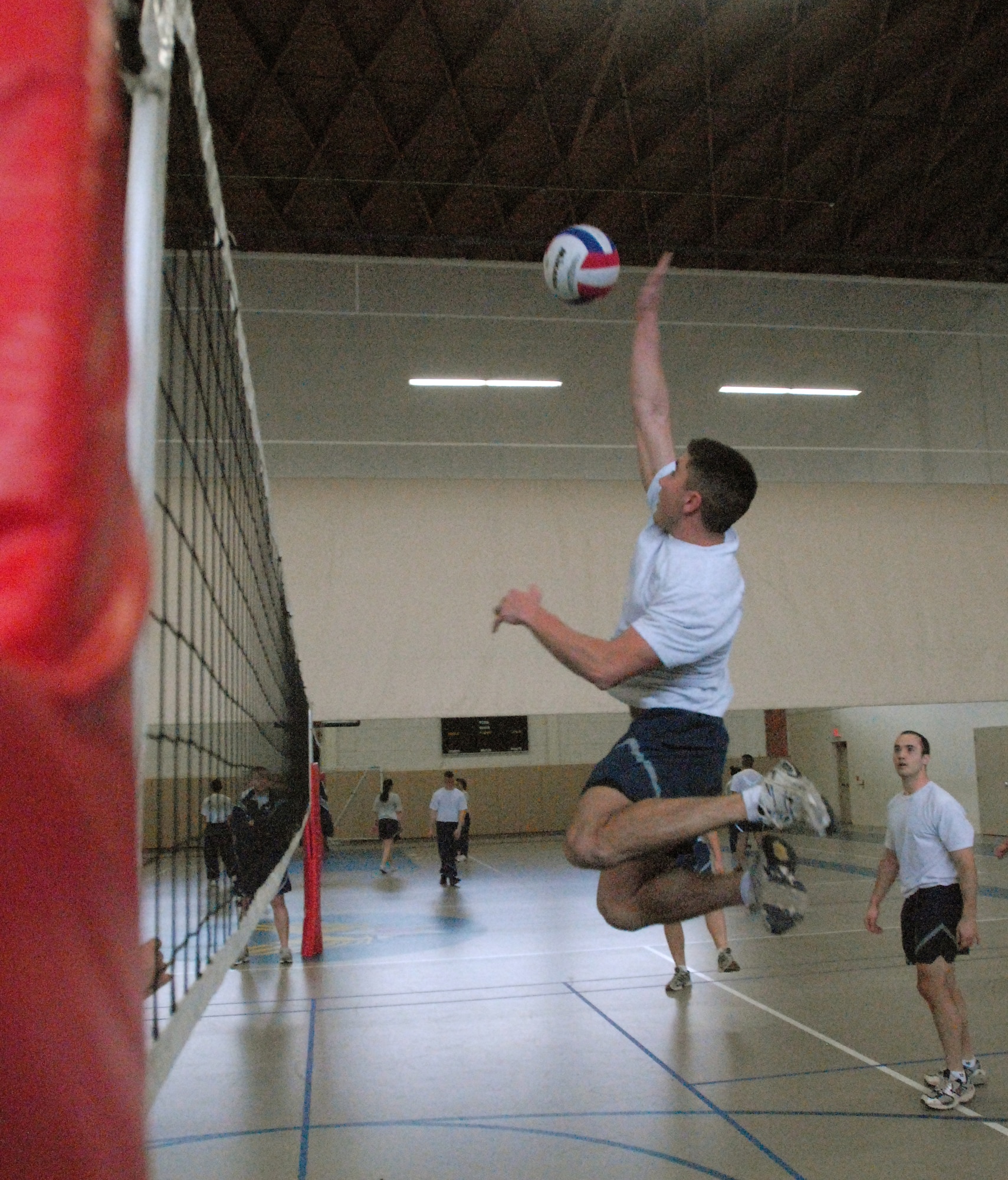 2nd Lt. Phil Rose, 315th Training Squadron, goes to spike the ball during a volleyball match as part of the 17th Training Wing Sports Day on Feb. 12.  Goodfellow AFB, Texas took the day to hold multiple sporting events, including volleyball, tennis, and dodge ball, with each unit competing for commander’s cup points.  (U.S. Air Force photo/Master Sgt. Randy Mallard)