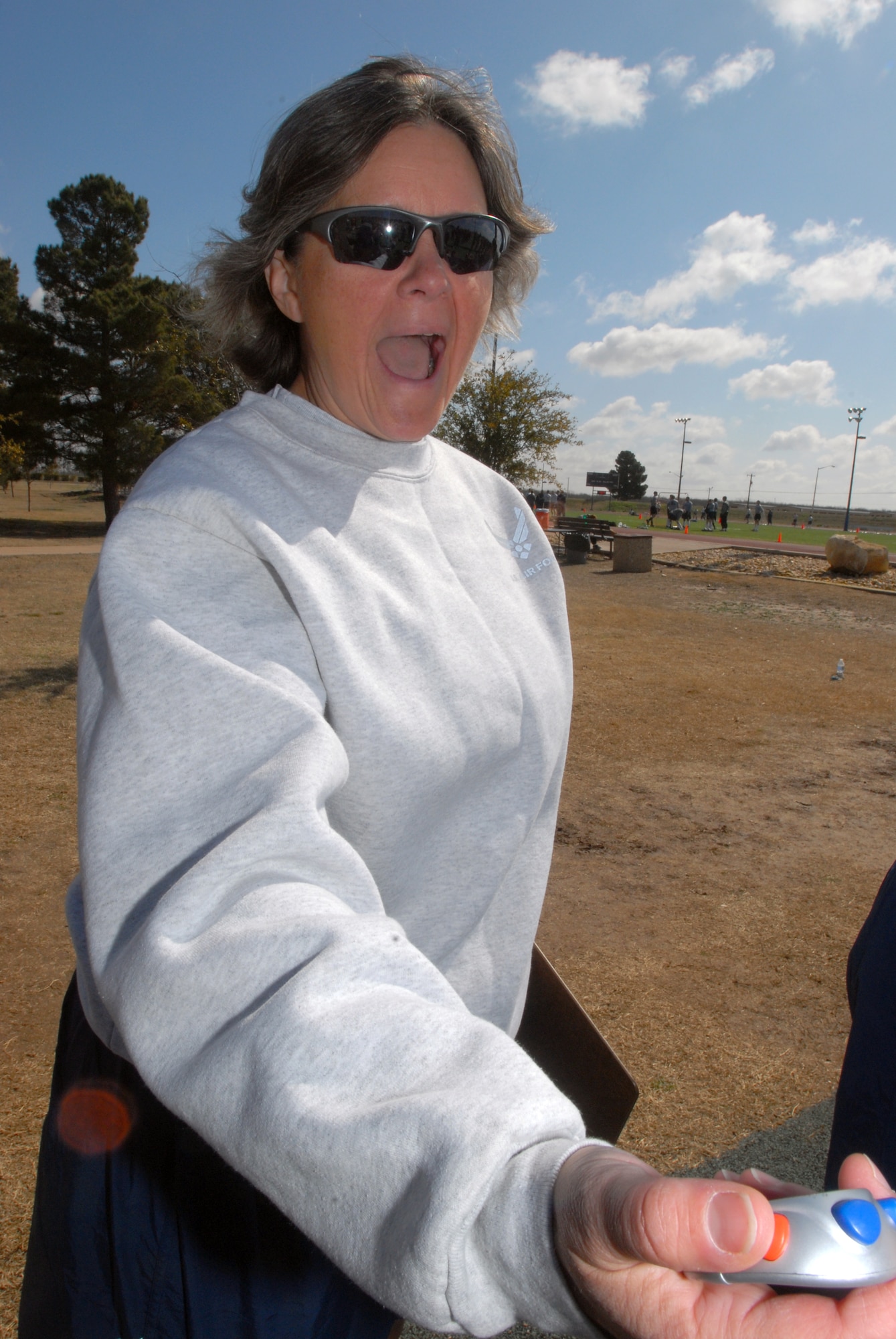 Senior Master Sgt. Susan Lantz, 17th Training Support Squadron, calls out time during the pull-up, sit-up, and push-up competition as part of the 17th Training Wing Sports Day on Feb. 12. Goodfellow AFB, Texas took the day to hold multiple sporting events, including volleyball, tennis, and dodge ball, with each unit competing for commander’s cup points.  (U.S. Air Force photo/Master Sgt. Randy Mallard)