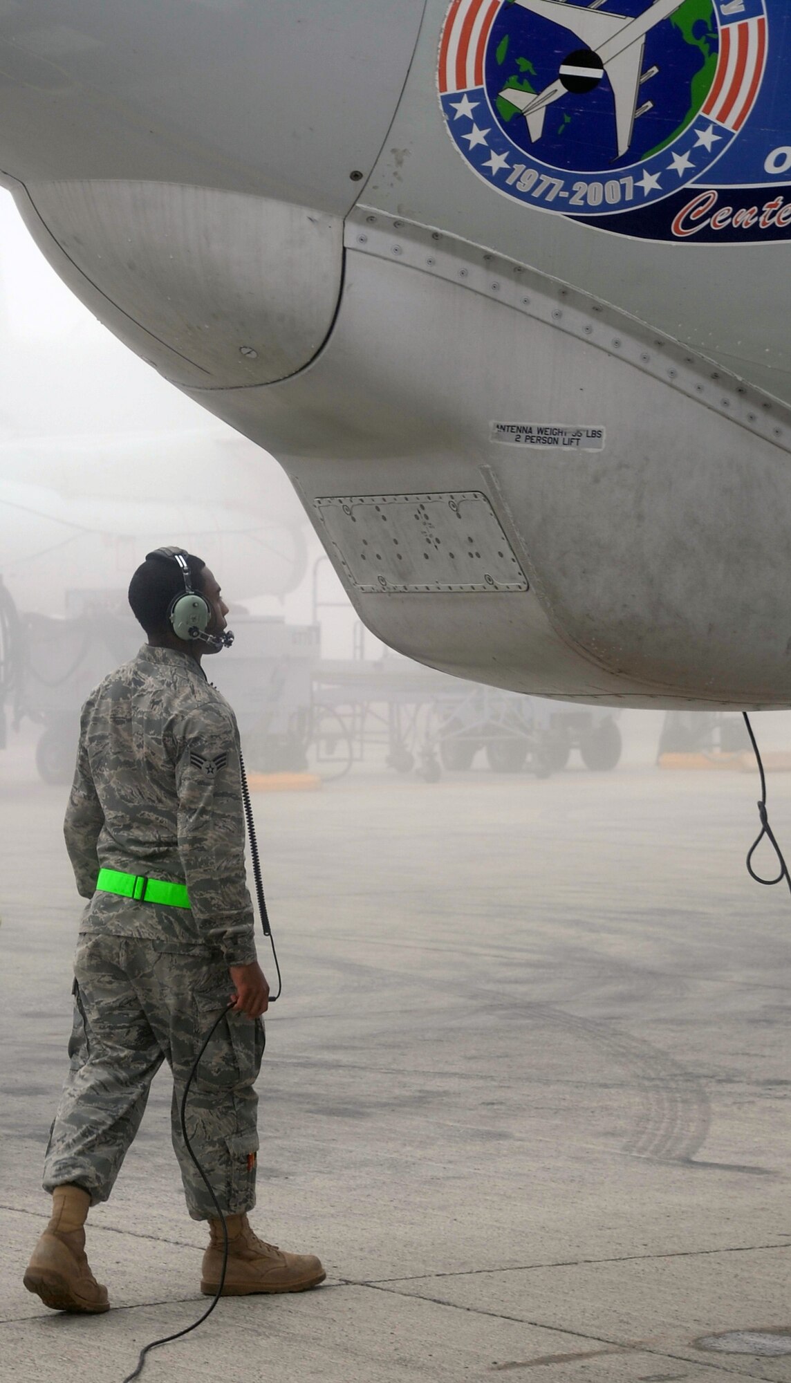 A maintenance Airman inspects an E-3 Sentry Airborne Warning and Control System aircraft that is shrouded by fog on the flightline of the 380th Air Expeditionary Wing at a non-disclosed base in Southwest Asia on Feb. 16, 2010. The E-3, which is assigned to the 965th Expeditionary Airborne Air Control Squadron, is deployed from Tinker Air Force Base, Okla.  The 380th AEW supports operations Iraqi Freedom and Enduring Freedom and the Combined Joint Task Force-Horn of Africa.  (U.S. Air Force Photo/Master Sgt. Scott T. Sturkol/Released)