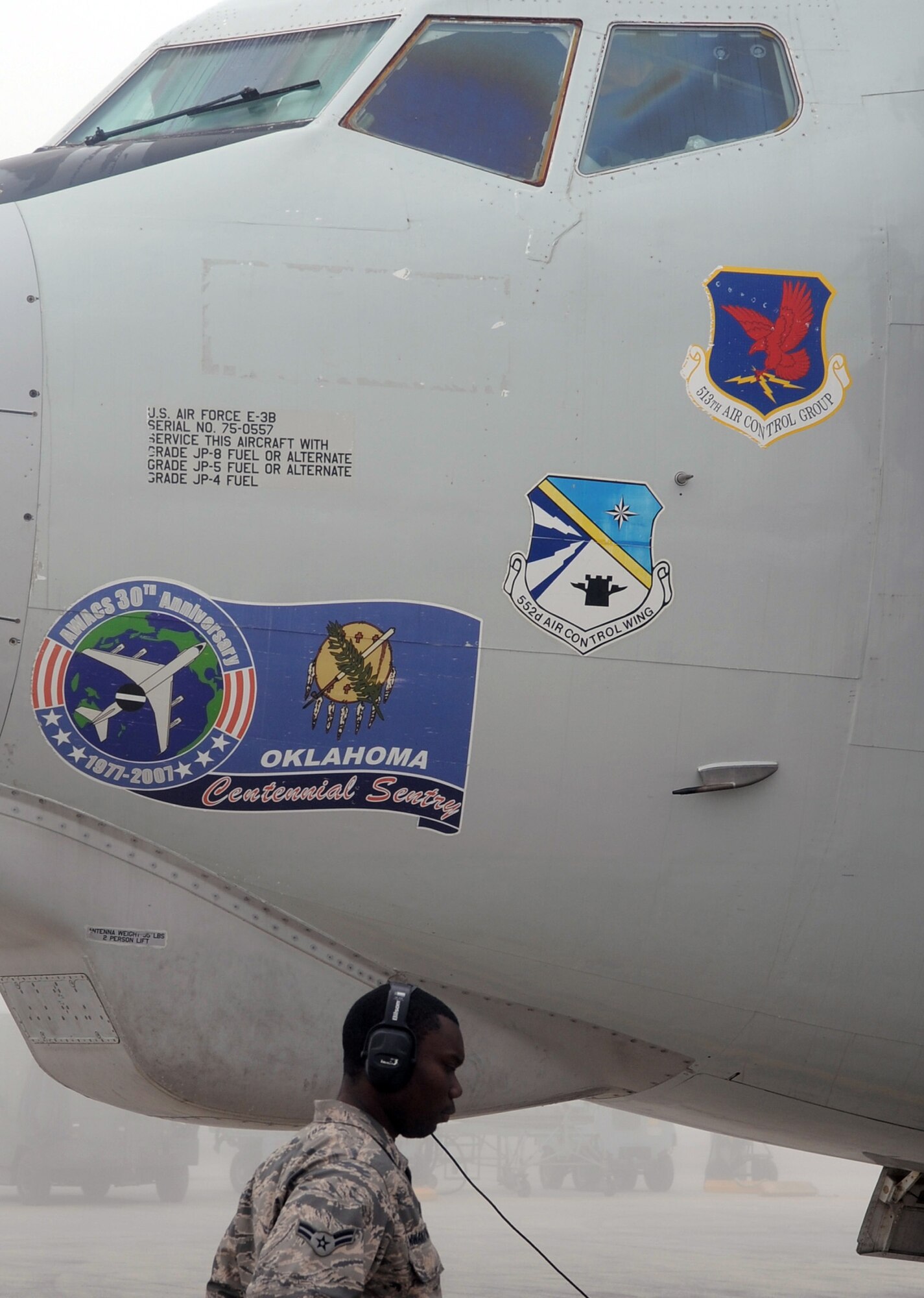 A maintenance Airman inspects an E-3 Sentry Airborne Warning and Control System aircraft that is shrouded by fog on the flightline of the 380th Air Expeditionary Wing at a non-disclosed base in Southwest Asia on Feb. 16, 2010. The E-3, which is assigned to the 965th Expeditionary Airborne Air Control Squadron, is deployed from Tinker Air Force Base, Okla.  The 380th AEW supports operations Iraqi Freedom and Enduring Freedom and the Combined Joint Task Force-Horn of Africa.  (U.S. Air Force Photo/Master Sgt. Scott T. Sturkol/Released)