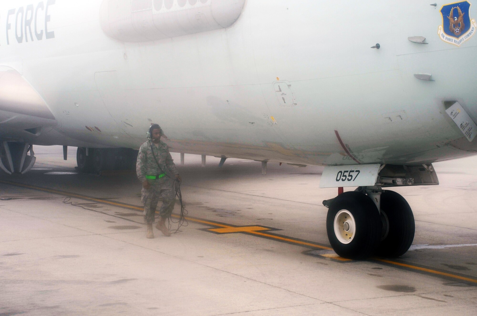 A maintenance Airman inspects an E-3 Sentry Airborne Warning and Control System aircraft that is shrouded by fog on the flightline of the 380th Air Expeditionary Wing at a non-disclosed base in Southwest Asia on Feb. 16, 2010. The E-3, which is assigned to the 965th Expeditionary Airborne Air Control Squadron, is deployed from Tinker Air Force Base, Okla.  The 380th AEW supports operations Iraqi Freedom and Enduring Freedom and the Combined Joint Task Force-Horn of Africa.  (U.S. Air Force Photo/Master Sgt. Scott T. Sturkol/Released)