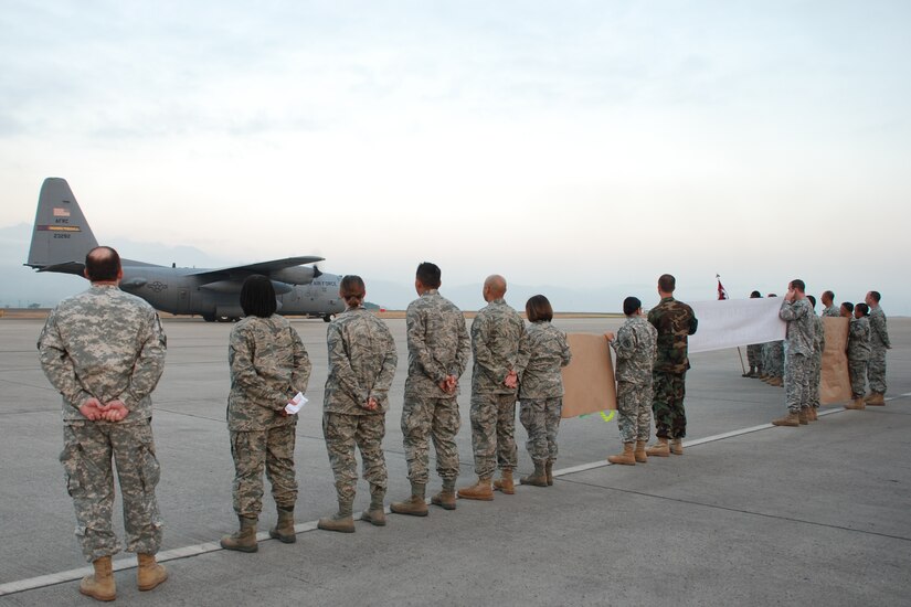 Medical Element personnel await the return of fellow unit members to Soto Cano Air Base, Honduras, on the base flight-line Feb. 15. Twenty-three members of Joint Task Force-Bravo's Medical Element returned Feb. 15 and 16 after spending 28 days in Haiti and providing care to nearly 3,000 Haitians in need. The team from Joint Task Force-Bravo was part of Operation Unified Response, the U.S. military's disaster relief mission led by U.S. Southern Command's Joint Task Force-Haiti. (U.S. Air Force photo by 1st Lt. Jen Richard)