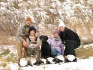 MINOT, N.D. – Tech. Sgt. Thomas Dow (left), 5th Bomb Wing public affairs, poses for a photo with his wife and two daughters following a goose hunt in the fall of 2008. (Photo courtesy of Tech. Sgt. Thomas Dow)