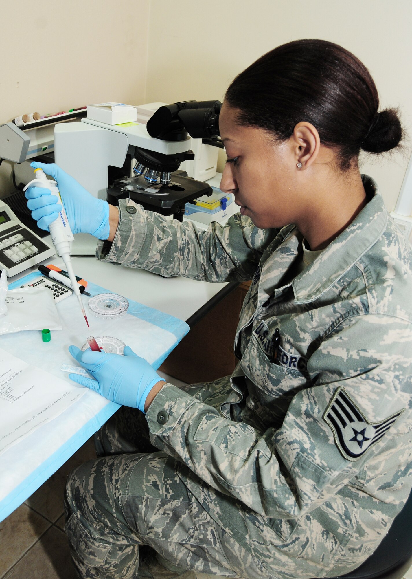 Staff Sgt. Carmen Williams uses a blood sample to test a patient's liver functions Feb. 15, 2010 at an air base in Southwest Asia. Sergeant Williams, deployed from Wright-Patterson Air Force Base, Ohio, was part of the her home unit's Air Force Medical Service Award winning Category I Laboratory Team of the Year. She is with the 386th Expeditionary Medical Group. (U.S. Air Force photo by Staff Sgt. Lakisha A. Croley/Released)

