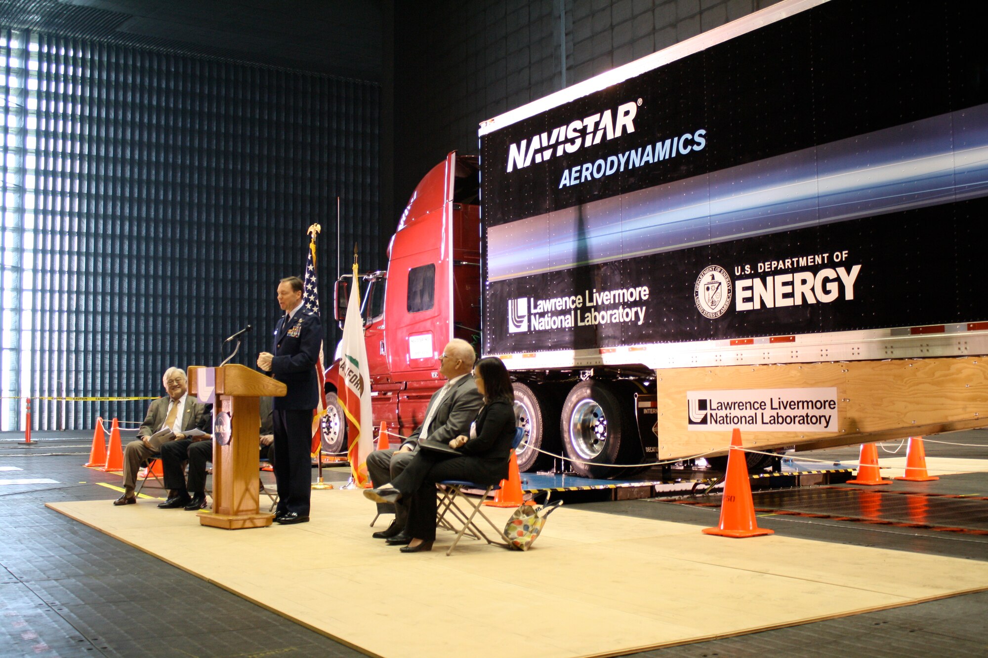 AEDC Commander Col. Michael Panarisi speaks at a media event Feb. 16 at the AEDC-operated National Full-Scale Aerodynamics Complex at NASA Ames in California. The media event was held to inform the public about the Department of Energy sponsored truck test at NFAC. The truck's trailer has been outfitted with special aerodynamic attachments, which is the focus of the test program. (Air Force by Joel Fortner)