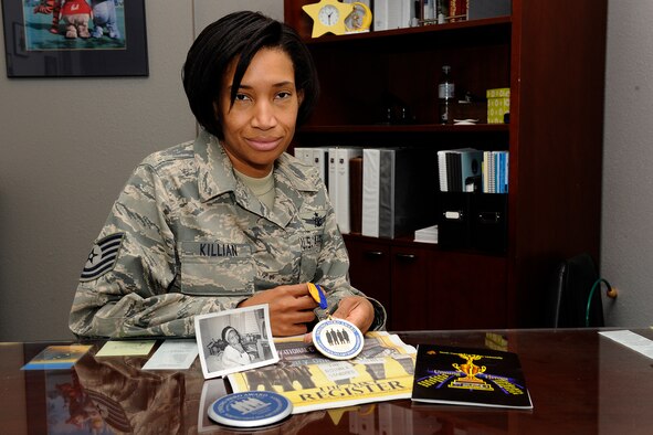 Tech. Sgt. Monique Killian, 21st Space Wing Inspector General flight chief, wing readiness, holds the “Unsung Hero” medal given to her mom, Ann Staples Shelton, Feb. 1, in Greensboro, N.C. at the 50th anniversary of the Greensboro sit-ins, which ignited the 1960s civil rights movement. Ms. Shelton, who passed away six years ago, was honored for her work during the sit-ins, which began with four college students at F.W. Woolworth Co. (Air Force photo by Craig Denton)
