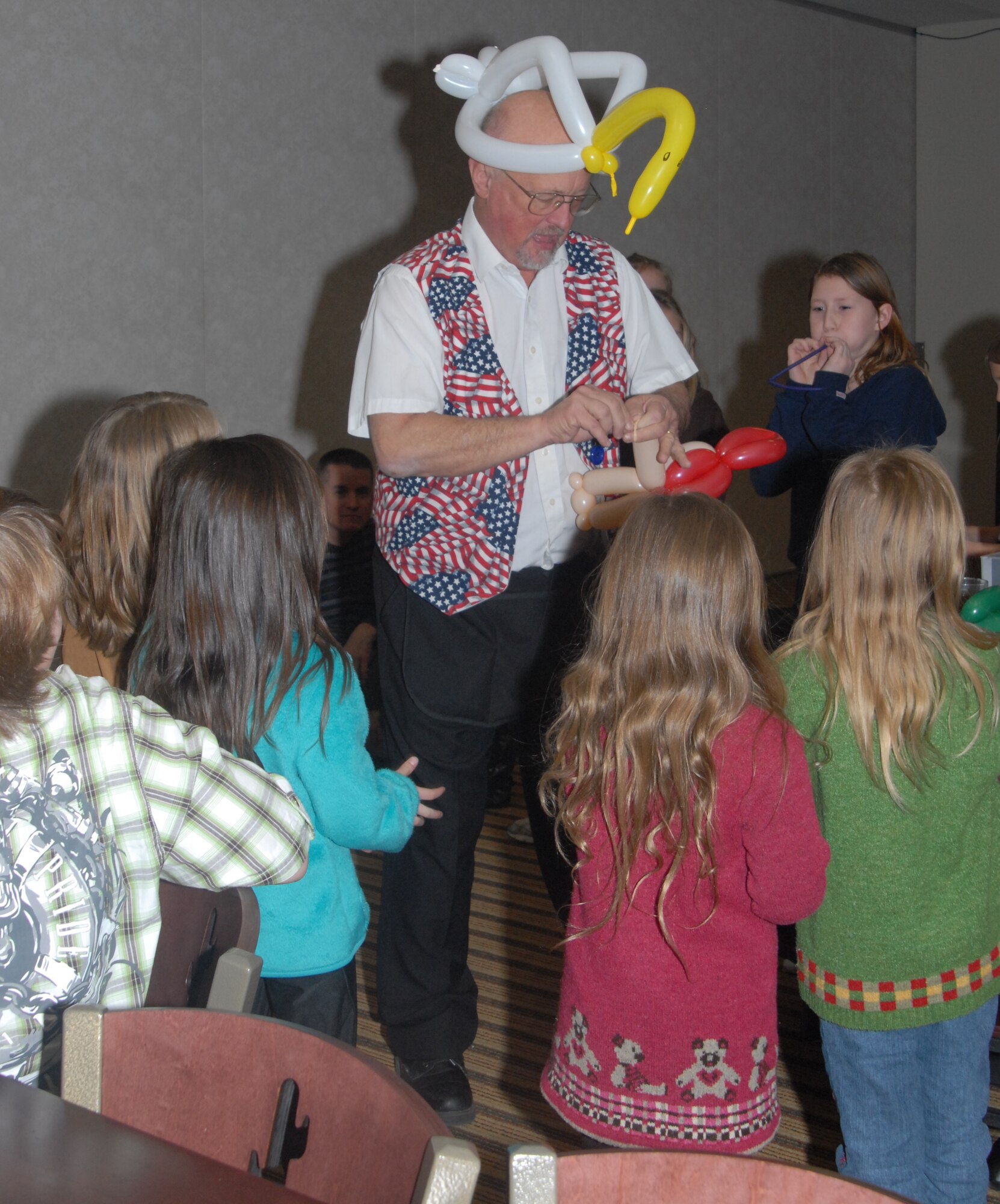 Mr. Kelton, the clown, entertains kids during the Key Spouses dinner hosted at the Event Center, Thursday night. ( U.S. Air Force photo by Airman 1st Class Anne Gathua)