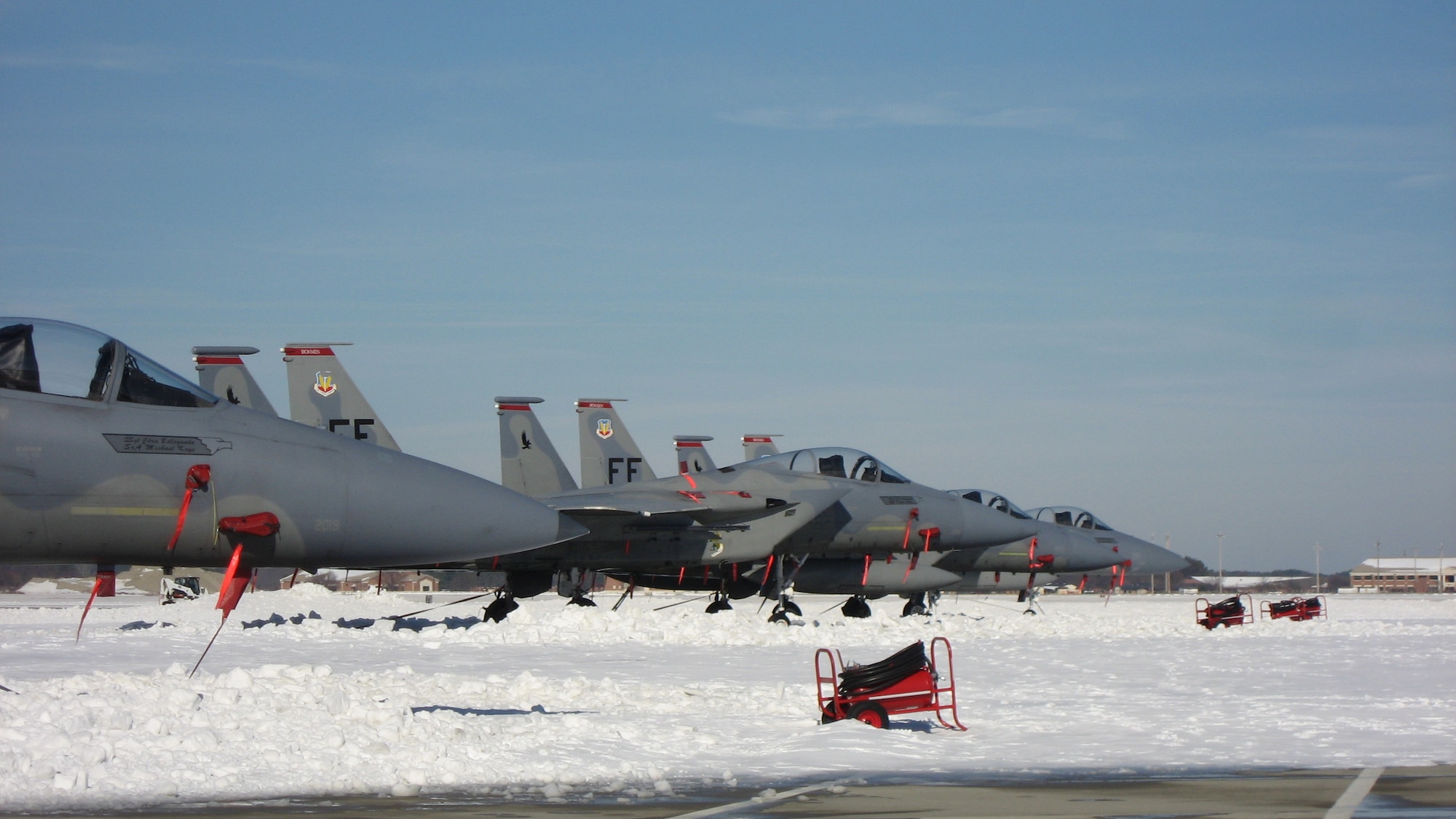LANGLEY AIR FORCE BASE, Va. – F-15C Eagles from the 71st Fighter Squadron sit on the snow-covered airfield Feb. 1. 633d Civil Engineer Squadron crews worked around the clock to clear the flight line and taxiways to ensure continuation of critical homeland security and humanitarian missions. (U.S. Air Force photo/Col. Matt Molloy)