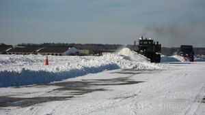 LANGLEY AIR FORCE BASE, Va. -- 633d Civil Engineer Squadron crews use heavy-duty plows to remove snow from the flight line Feb. 1. The teams cleared the initial snowfall from the airfield within 24 hours, ensuring critical homeland security and humanitarian missions were uninterrupted. (U.S. Air Force photo/Col. Matt Molloy)