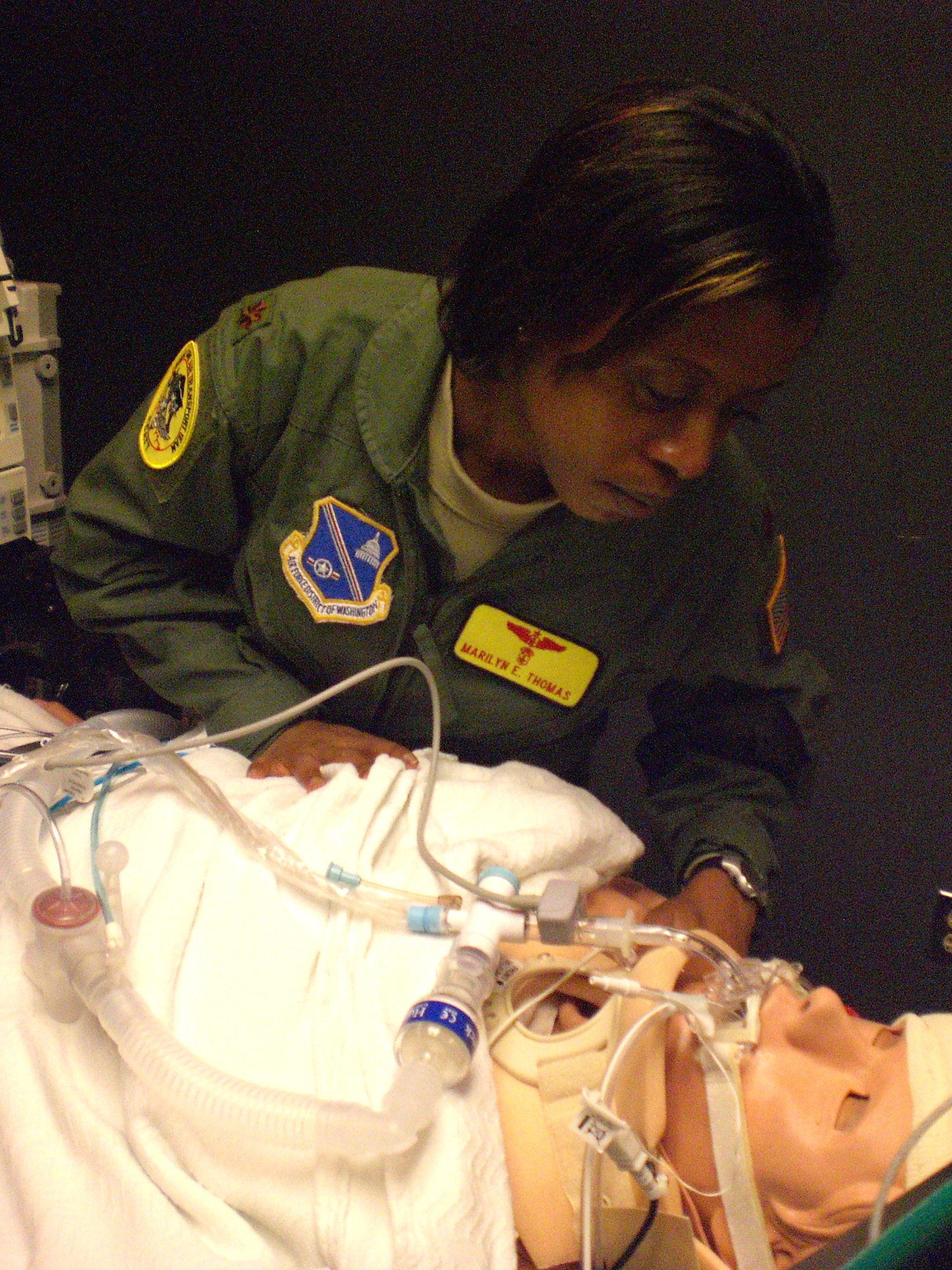 Maj. Marilyn Thomas, a critical care nurse from Andrews Air Force Base, Md., looks at one of the human patient simulator manikins inside the Air Force’s Centers for Sustainment of Trauma and Readiness Skills (CSTARS) at University Hospital Cincinnati. Maj. Thomas, already a flight nurse for aeromedical evacuation missions, is training to become a critical care air transport team (CCATT) member. CSTARS Cincinnati trains CCATT members and evaluates their readiness to fly missions downrange. (U.S. Air Force photo/Derek Kaufman)