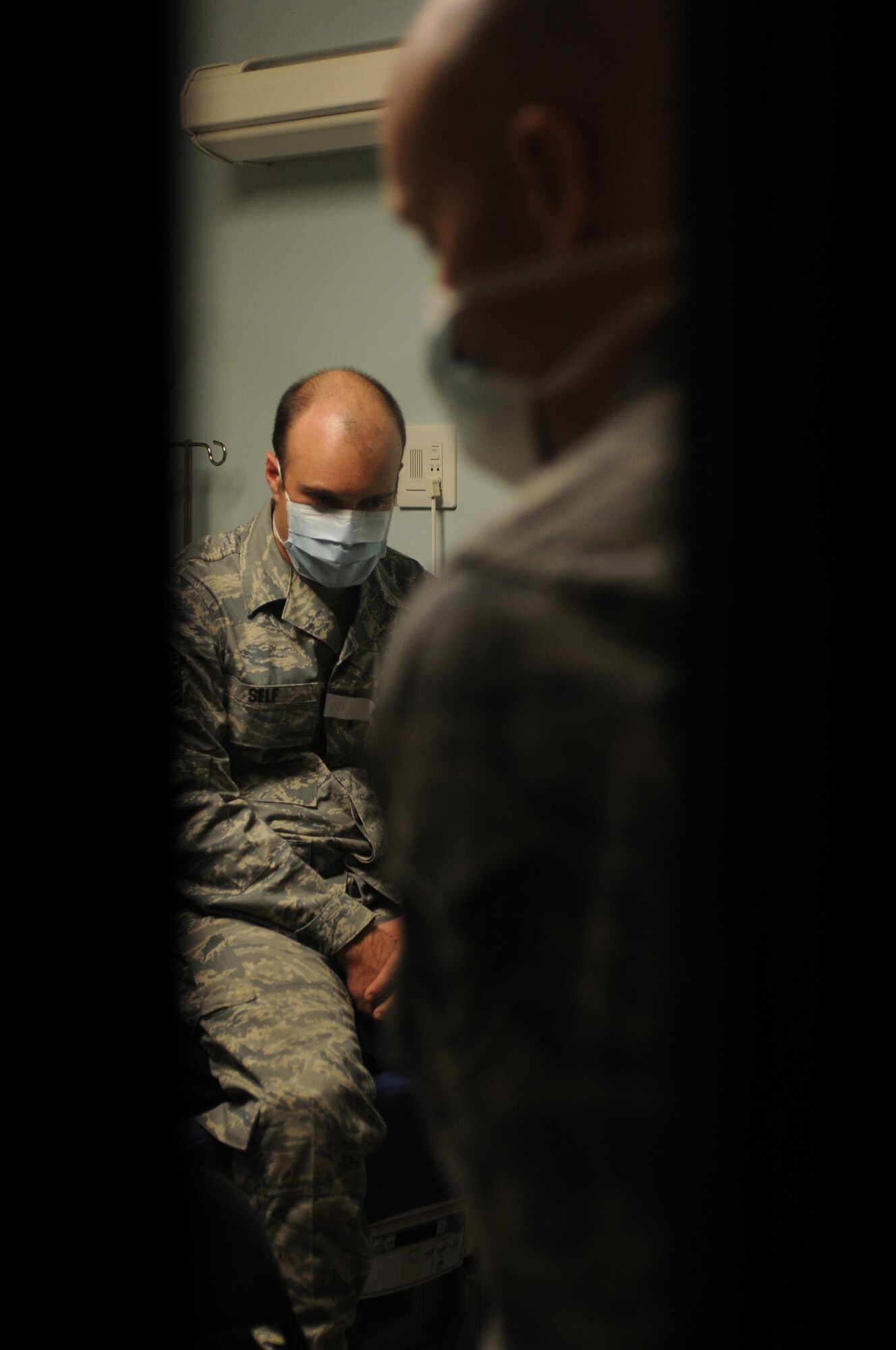 Tech. Sgt. Christopher Self, 39th Logistics Readiness Squadron, and Staff Sgt. Andrew Wilson, 39th Force Support Squadron, wait in the holding area during a disease outbreak exercise Wednesday, Feb. 10, 2010 on Incirlik Air Base, Turkey.  A holding area is established to separate infected people from the rest of the base.  (U.S. Air Force photo/Senior Airman Ashley Wood)  