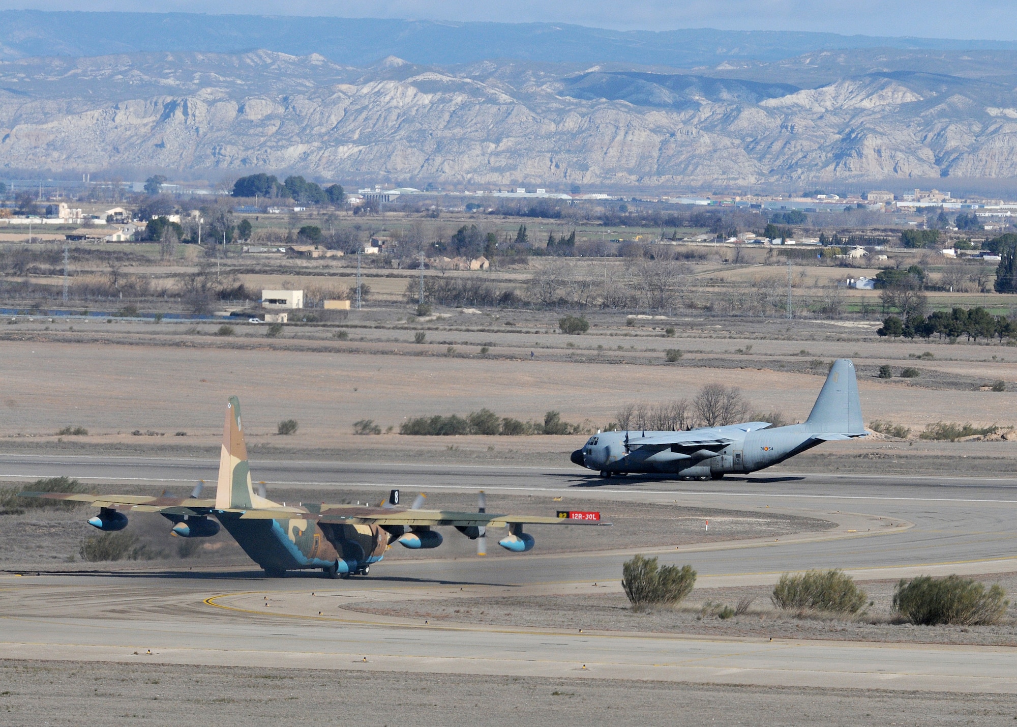 An Air Force C-130 and a Spanish air force C-17 prepare for takeoff from Zaragoza Air Base, Spain, on February 1, 2010.  U.S. and Spanish Air Forces shared a runway and airspace during the 555th Fighter Squadron's 2010 Training Deployment to Spain. (U.S. Air Force photo/Senior Airman Tabitha M. Mans)