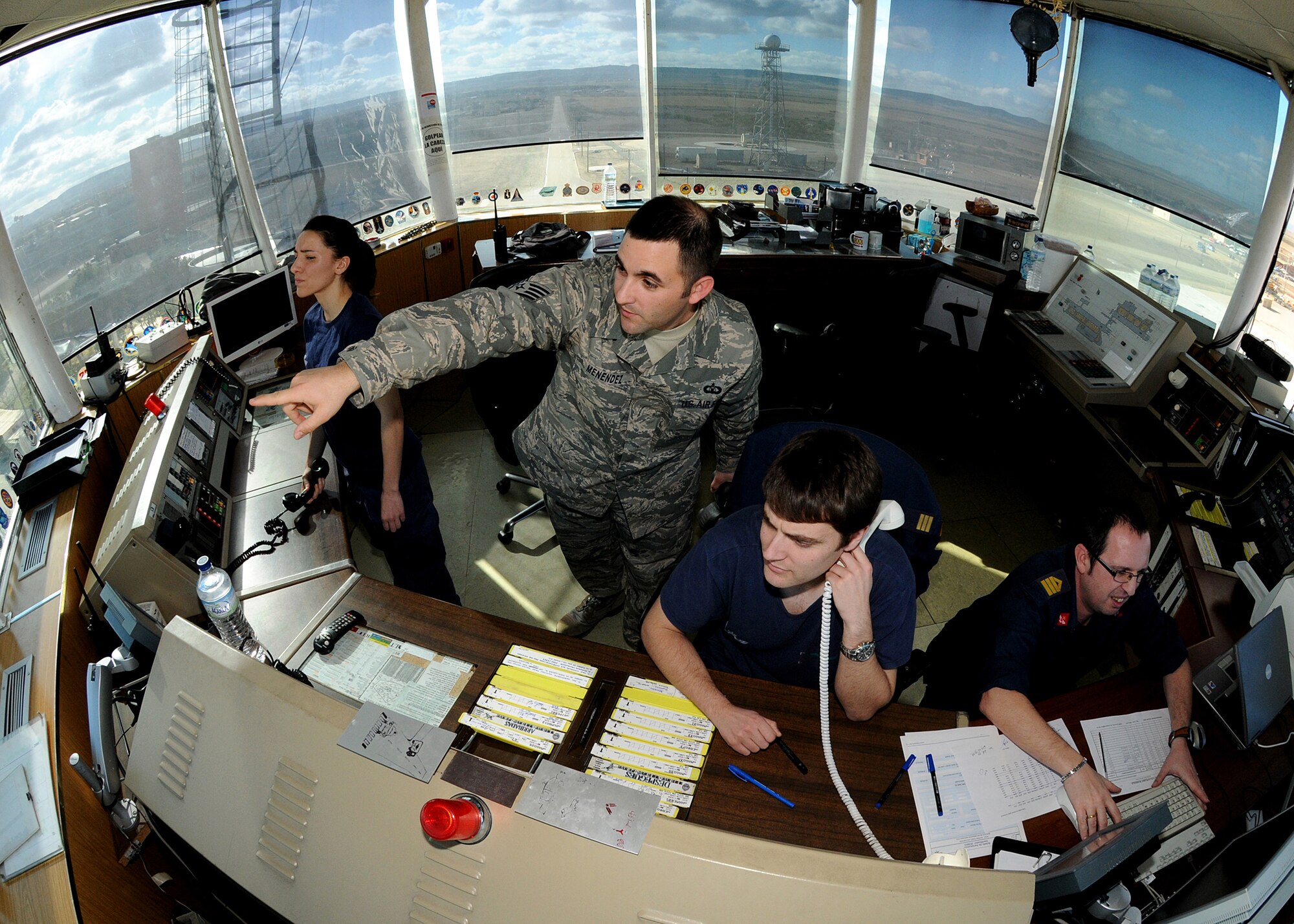 Staff Sgt. Joe Menendez, air traffic control liaison for Spain, assists Spanish Air Force air traffic controllers, February 1, 2010, at Zaragoza Air Base, Spain.  Sergeant Menendez ensures proper communication between the U.S. pilots and Spanish ATC's to maintain safe missions.  (U.S. Air Force photo/Senior Airman Tabitha M. Mans)