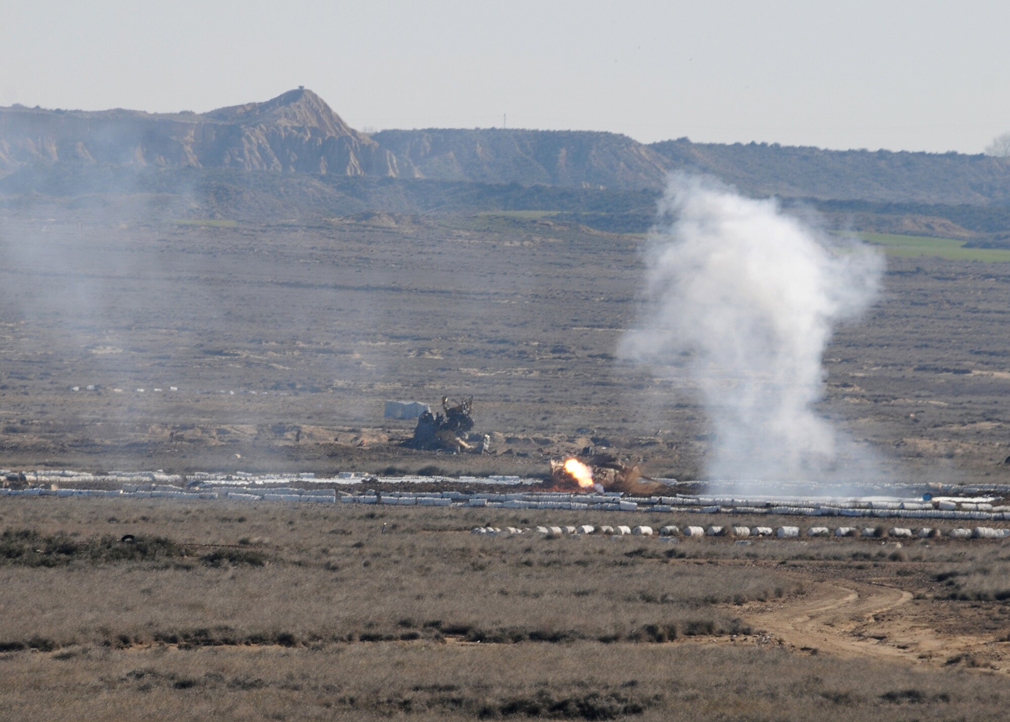 A BDU-33, a small cast-iron and steel non explosive ordnance that is used in training to simulate actual bombs, detonates at a practice range outside of Zaragoza Air Base, Spain, on February 2, 2010.  The 555th Fighter Squadron deployed to Spain in order to accomplish NATO required training.(U.S. Air Force photo/Senior Airman Tabitha M. Mans)