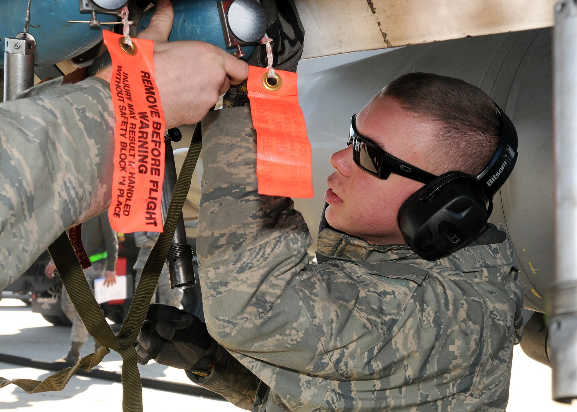 Airman 1st Class Nicholas Stockbridge, 555th Aircraft Maintenance Unit, loads a BDU-33, a small cast-iron and steel non explosive ordnance that is used in training to simulate actual bombs, on to an F-16 at Zaragoza Air Base, Spain, February 3, 2010.  During their deployment here, approximately 1,132 BDU-33's were loaded to F-16's for training operations.  (U.S. Air Force photo/Senior Airman Tabitha M. Mans)