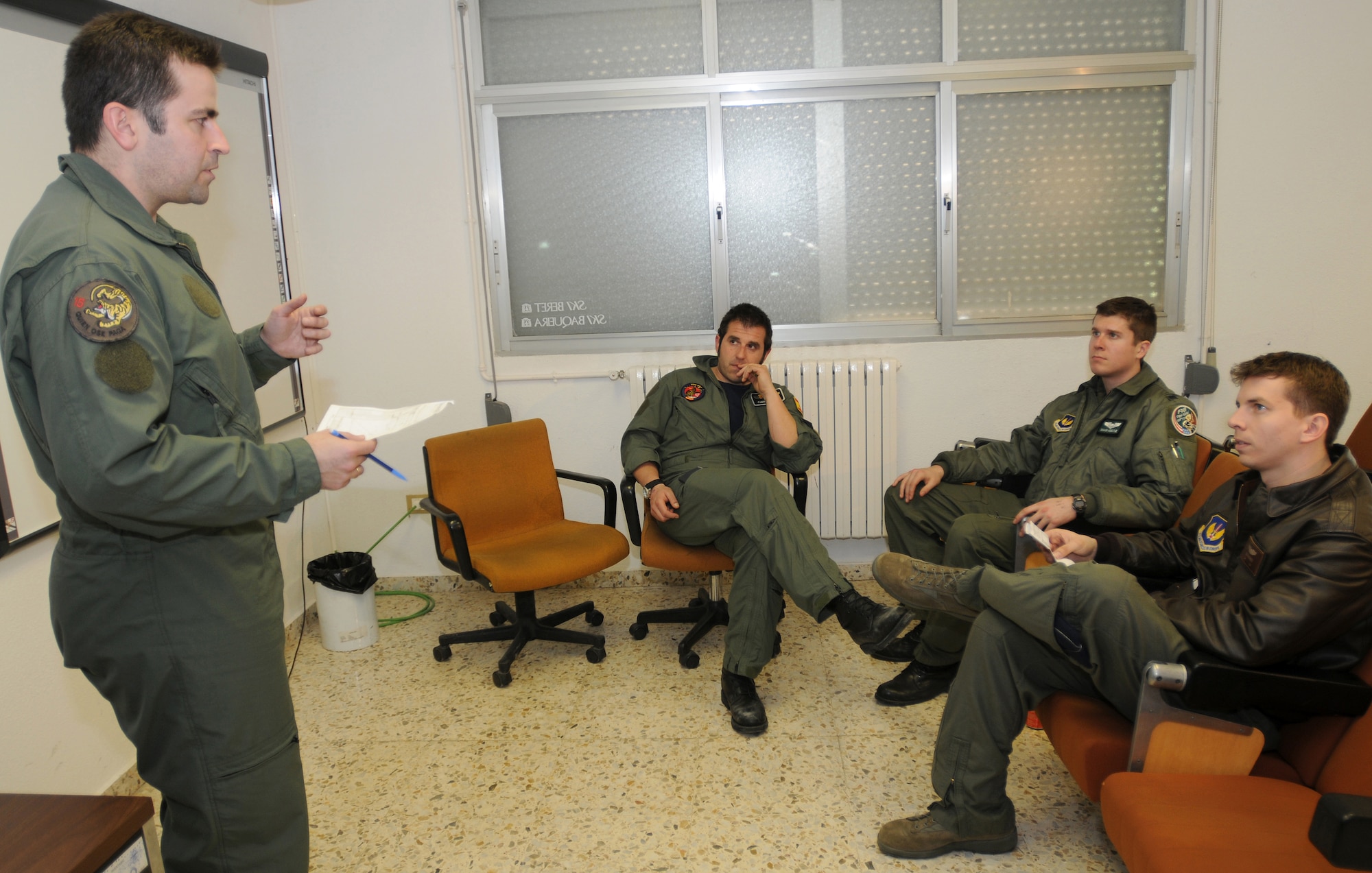 United States and Spanish Air Force fighter pilots debrief after an air-to-air combat training exercise at Zaragoza Air Base, Spain.  During debriefings both forces shared what they learned from the experience.  (U.S. Air Force photo/Senior Airman Tabitha M. Mans)