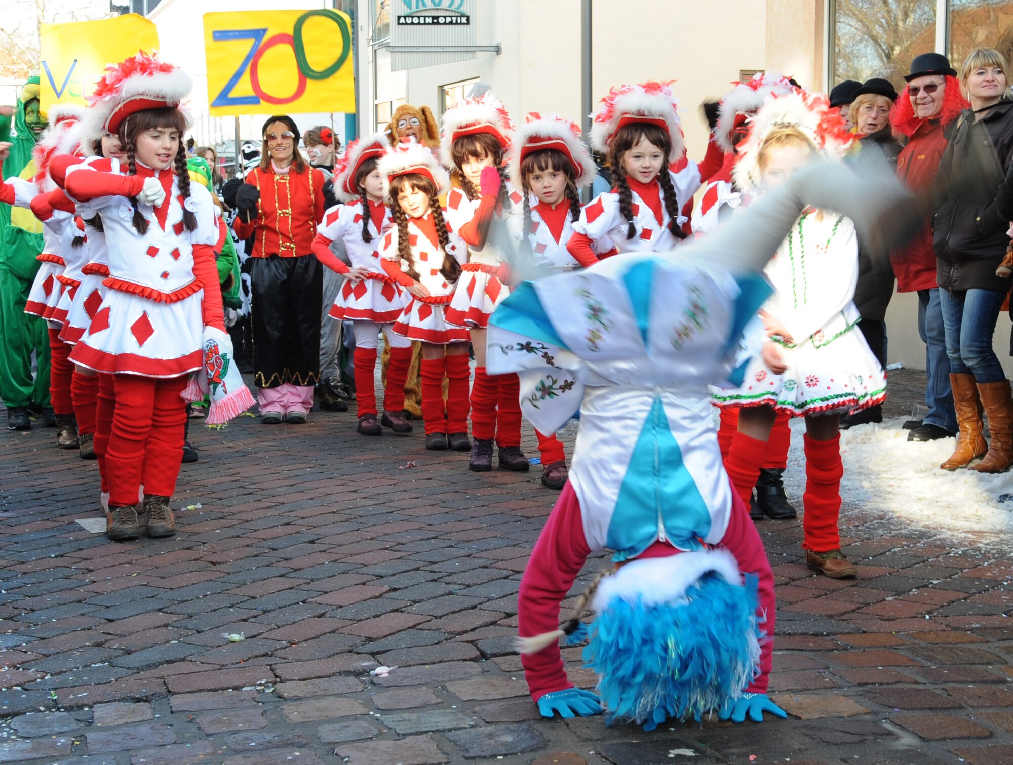 A child from a local community organization does summersaults down the road during a Fasching parade in Ramstein village, Germany, Feb. 16, 2010. This annual event is a pre-Lenten carnival which is celebrated with the donning of wild and fancy costumes to chase away the evil spirits of winter in preparation for spring. (U.S. Air Force photo by Airman 1st Class Caleb Pierce)