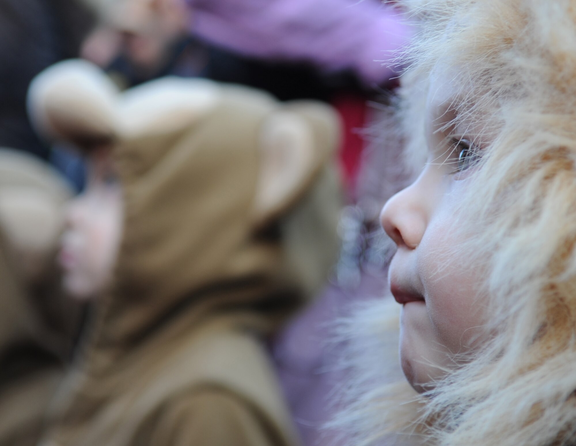 Children from local and the Kaiserslautern Military Communities watches for candy to be thrown from the people in the parade during the Fasching in Ramstein village, Germany, Feb. 16, 2010. This annual event is a pre-Lenten carnival which is celebrated with the donning of wild and fancy costumes to chase away the evil spirits of winter in preparation for spring. (U.S. Air Force photo by Airman 1st Class Caleb Pierce)