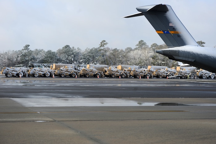 Mine-resistant, ambush-protected all-terrain vehicles painted tan sit draped in white snow on the flightline at Joint Base Charleston Feb. 13 after an overnight snowstorm delivered more than three inches of snow to the base. According to base weather flight personnel, the storm was moderate at best, starting as rain, progressing to sleet and finally forming snow. The weather system produced the first storm bringing snowfall to Charleston in more than 10 years. (U.S. Air Force photo/Senior Airman Daniel Owen)