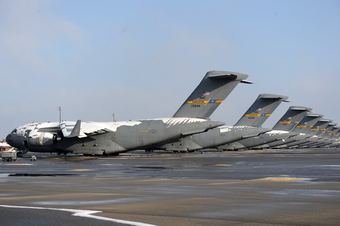 C-17 Globemaster III aircraft sit draped in snow on the flightline at Joint Base Charleston Feb. 13 after an overnight snowstorm delivered more than three inches of snow. During the recent winter months, nightly low temperatures have dropped and the use of deicing machines to clear aircraft of debilitating ice sheets is commonly required. The snowstorm was an uncommon event for the Charleston area, resulting in several delayed takeoffs due to the weather. (U.S. Air Force photo/Senior Airman Daniel Owen)