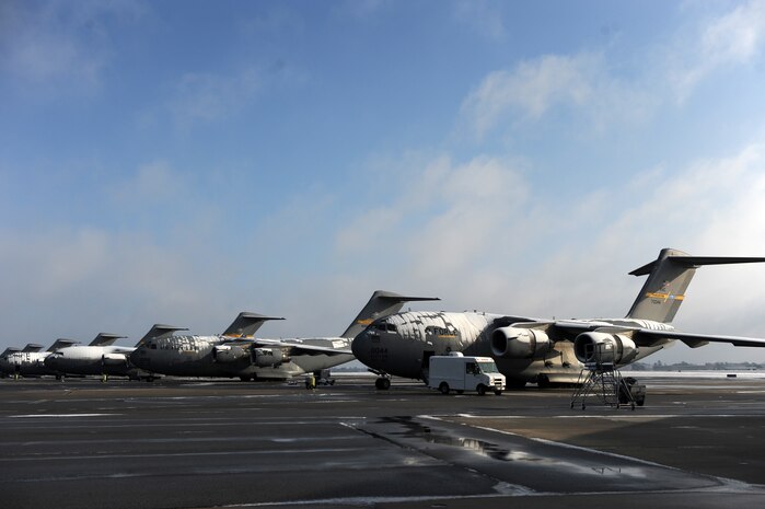 C-17 Globemaster III aircraft sit draped in snow on the flightline at Joint Base Charleston Feb. 13 after an overnight snowstorm delivered more than three inches of snow. According to base weather flight personnel, the storm was moderate at best, starting as rain, progressing to sleet and finally forming snow. The weather system produced the first snowstorm in Charleston since Jan. 25, 2000. (U.S. Air Force photo/Senior Airman Daniel Owen)