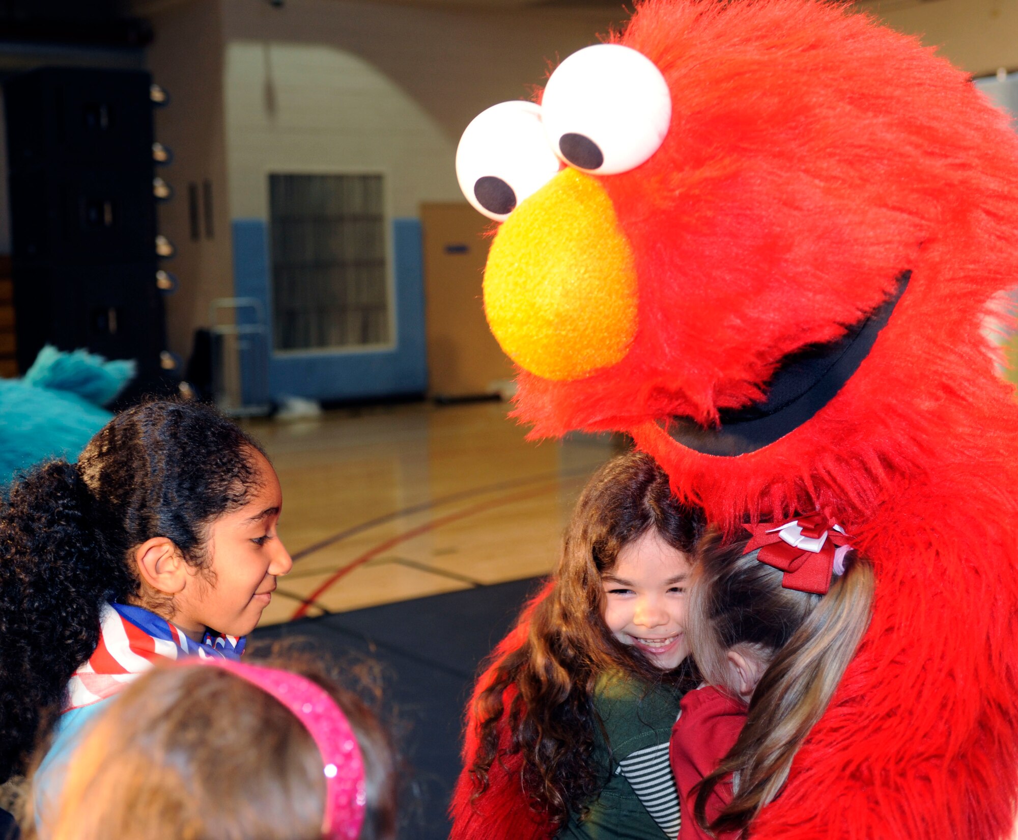 School age children enjoy a Sesame Street performance featuring five of the muppets in the base gym at Osan Air Base, Republic of Korea Feb. 12.  In January, the USO and Sesame Workshop kicked off “The Sesame Street/USO Experience for Military Families” tour. This year the tour will travel to Japan, Korea and Guam over the course of two months and deliver more family friendly shows tailored specifically for military families at 13 military installations.