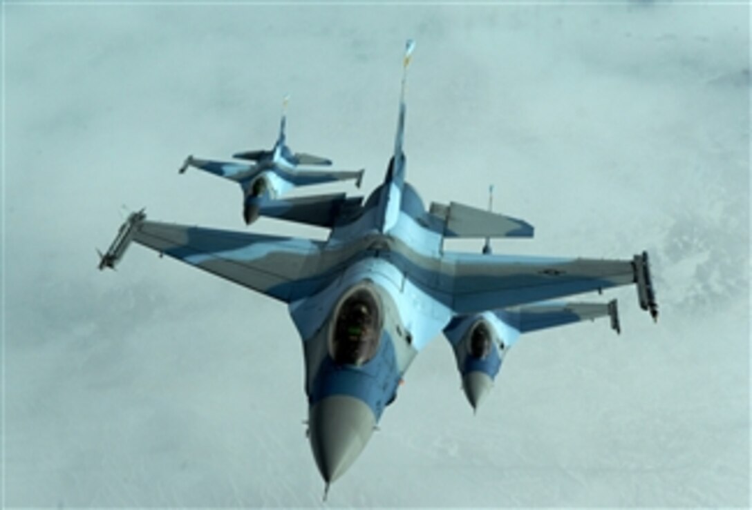 Three U.S. Air Force F-16 Fighting Falcon aircraft from the 64th Aggressor Squadron fly in formation after refueling during exercise Red Flag at Nellis Air Force Base, Nev., on Feb. 4, 2010.  Red Flag is a realistic combat training exercise involving the U.S. Air Force and its allies.  The exercise is conducted on the 15,000-square-mile Nevada Test and Training Range north of Las Vegas.  