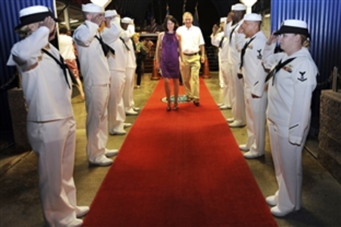 Deputy Defense Secretary William J. Lynn III and wife, Mary Murphy, walk through sideboys after taking a tour of the USS Arizona Memorial in Hawaii, Feb. 16, 2010.  