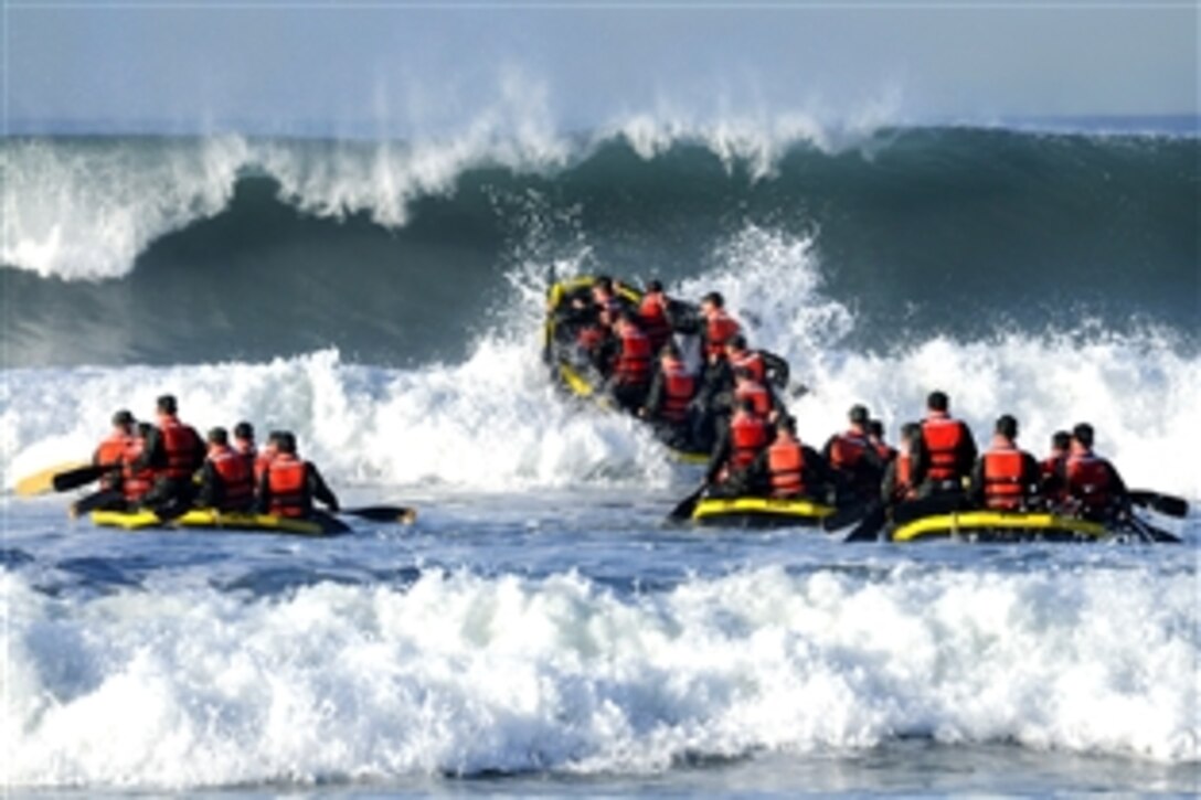U.S. Navy sailors enrolled in the Basic Underwater Demolition, a SEAL training course, participate in surf passage at Naval Amphibious Base Coronado, Calif., Feb. 16, 2010. Surf passage is one of many physical exercises conducted as part of the first phase of the training.