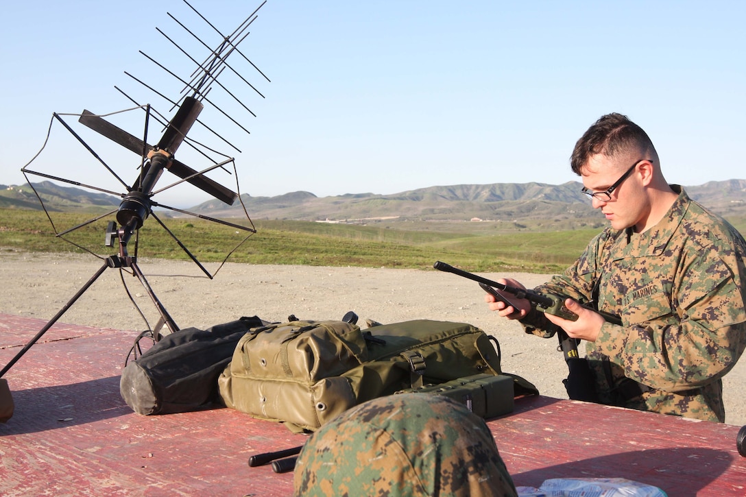 Lance Cpl. Joshua J. Martin, an aviation radio technician with Marine Tactical Air Command Squadron 38 sets up a PRC-117 radio before the rest of the MTACS-38 Marines enter the range at Marine Corps Base Camp Pendleton, Feb. 17.