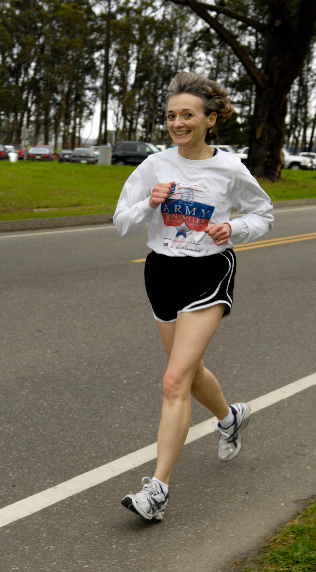 VANDENBERG AIR FORCE BASE, Calif. - With a sunny smile, Carolyn Winters finishes a five-kilometer run here Thursday, Feb. 11, 2010. Winters participated in the Vandenberg Fitness Center's Valentine's Day Family Fun Run. (U.S. Air Force photo/Airman 1st Class Lael Huss)