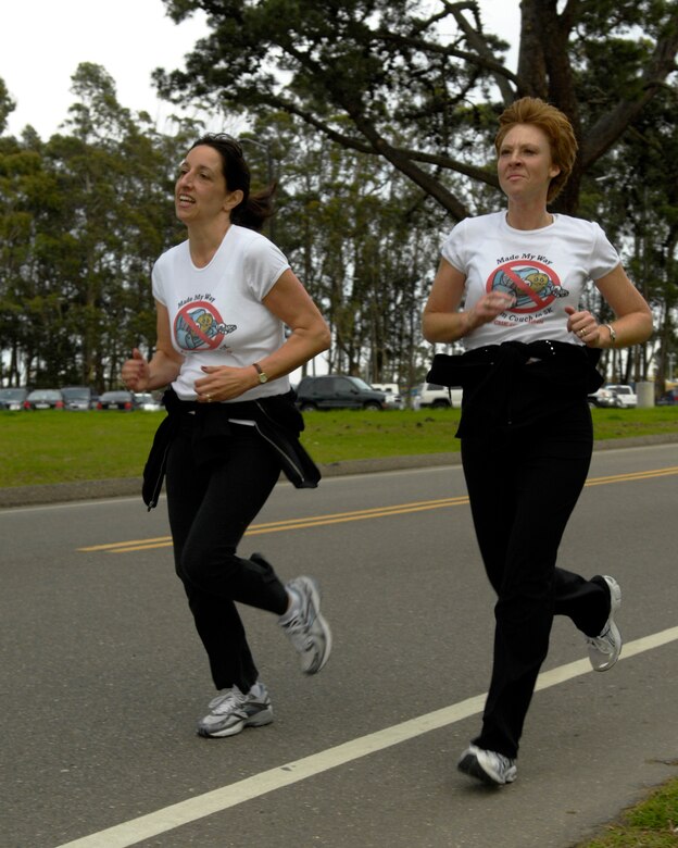 VANDENBERG AIR FORCE BASE, Calif. - Running partners Angela Diamanti and Kim Milner keep each other at a steady pace as they run the last few yards of a five-kilometer run here Thursday, Feb. 11, 2010. Diamanti and Milner both participated in the Vandenberg Fitness Center's Valentine's Day Family Fun Run. (U.S. Air Force photo/Airman 1st Class Lael Huss)