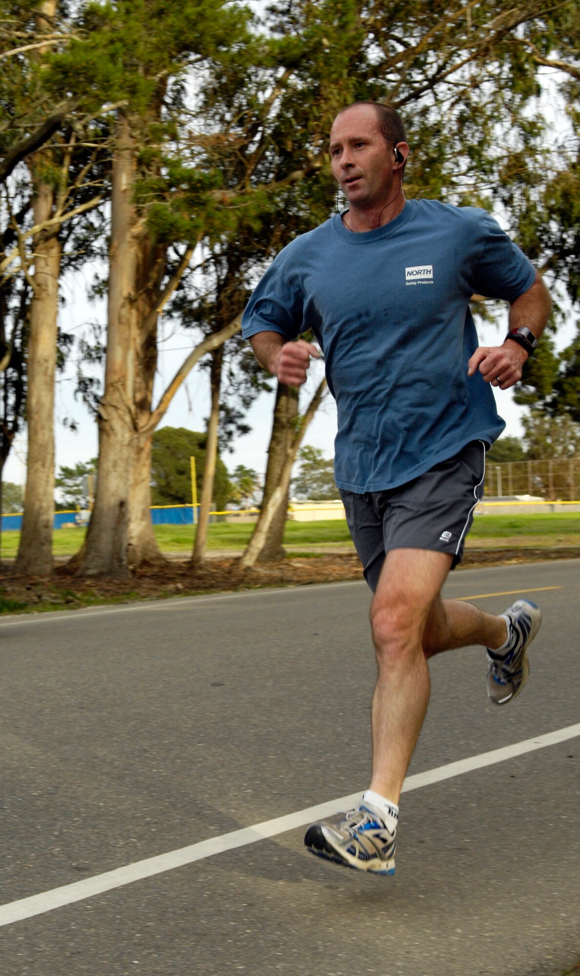 VANDENBERG AIR FORCE BASE, Calif. - In the lead, Bryan Eiler, with the Missile Defense Agency here, races down the home stretch of a five-kilometer run here Thursday, Feb. 11, 2010. Eiler participated in the Vandenberg Fitness Center's Valentine's Day Family Fun Run. (U.S. Air Force photo/Airman 1st Class Lael Huss)