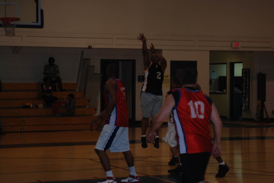 A player executes a jump shot at the March Air Reserve Base intramural basketball championship game Feb. 16, 2010. (U.S. Air Force photo by Staff Sgt. Kevin Chandler)