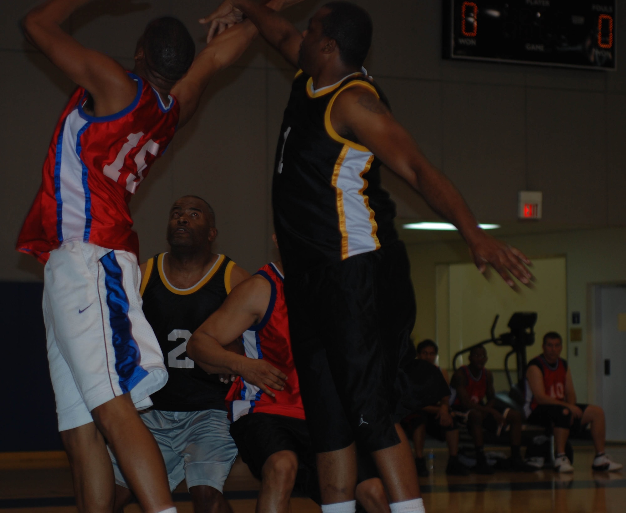 Players fight for the ball in the March Air Reserve Base intramural basketball championship game Feb. 16, 2010. (U.S. Air Force photo by Staff Sgt. Kevin Chandler)