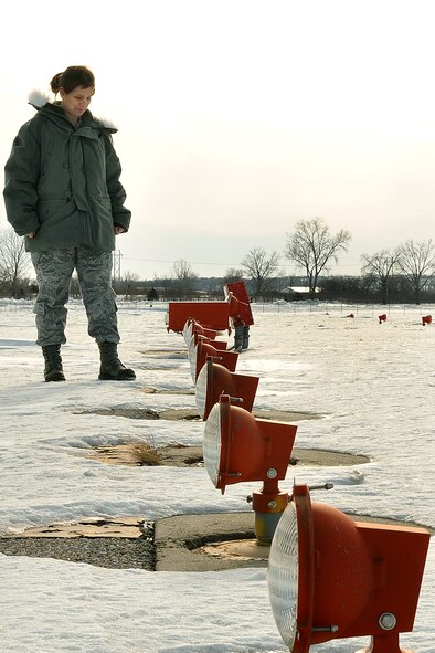 OFFUTT AIR FORCE BASE, Neb. - Senior Master Sgt. Laura Liedke, airfield manager with the 55th Operations Support Squadron, checks approach lights on the Offutt airfield to make sure they're operational Feb. 16. The Airfield Operations Flight airfield management team coordinates with various base agencies to provide a safe environment for aircraft operations. 

U.S. Air Force photo by Charles Haymond