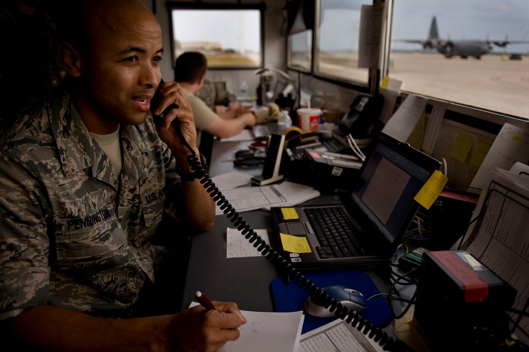 Tech. Sgt. Wayne Pennington helps control airflow traffic at Homestead Air Reserve Base, Fla. This influx of aircraft operate out of the base to assist with the Haiti earthquake relief efforts. Sergeant Pennington is from the 512th Airlift Control Flight. (U.S. Air Force photo by Tech. Sgt. Adrian Cadiz)
