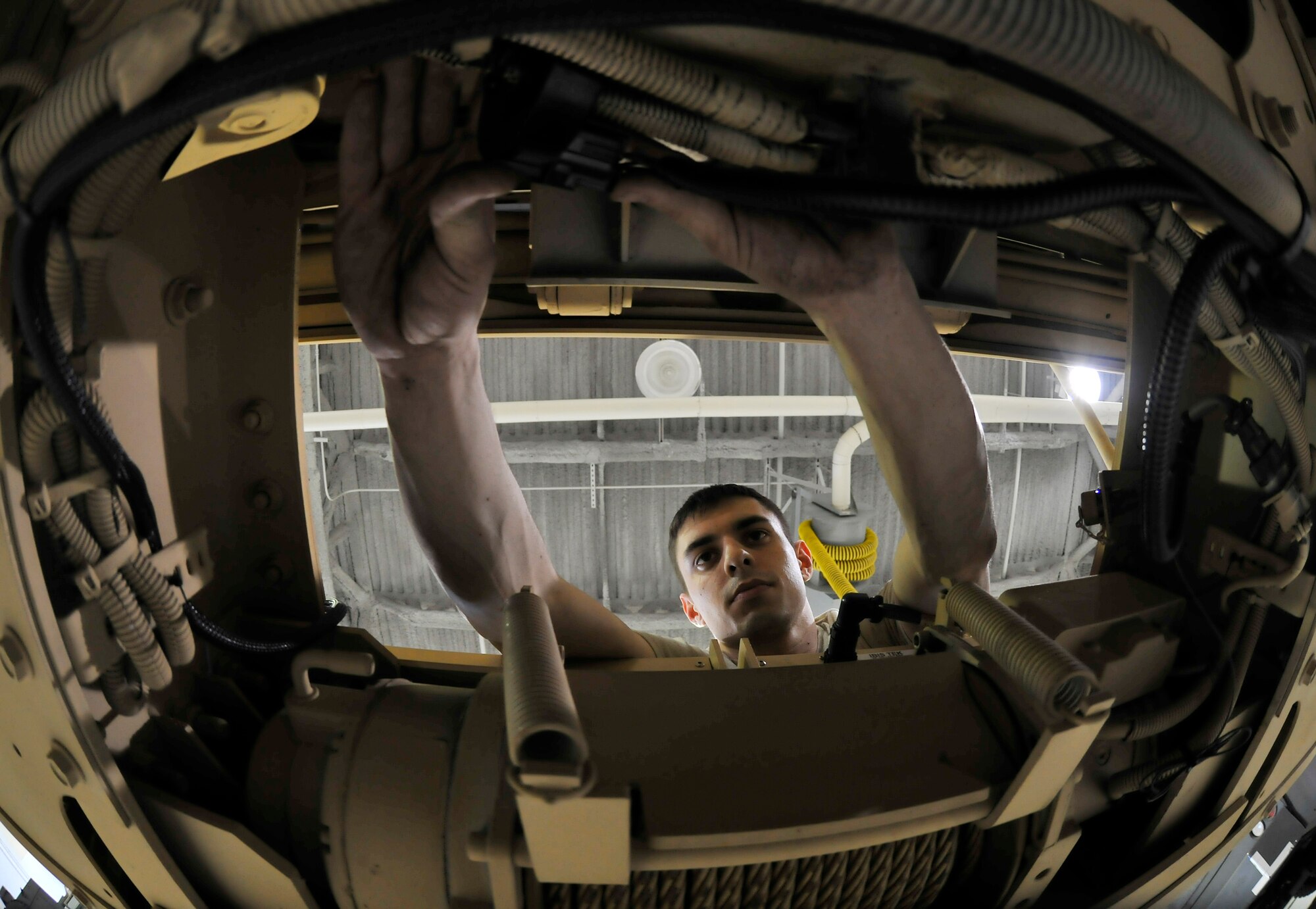 Senior Airman Rex Russell checks the wiring on a winch Feb. 17, 2010, Eielson Air Force Base, Alaska. Airman Russell is a mechanic assigned to the 354th Logistics Readiness Squadron. (U.S. Air Force photo/Staff Sgt. Christopher Boitz)