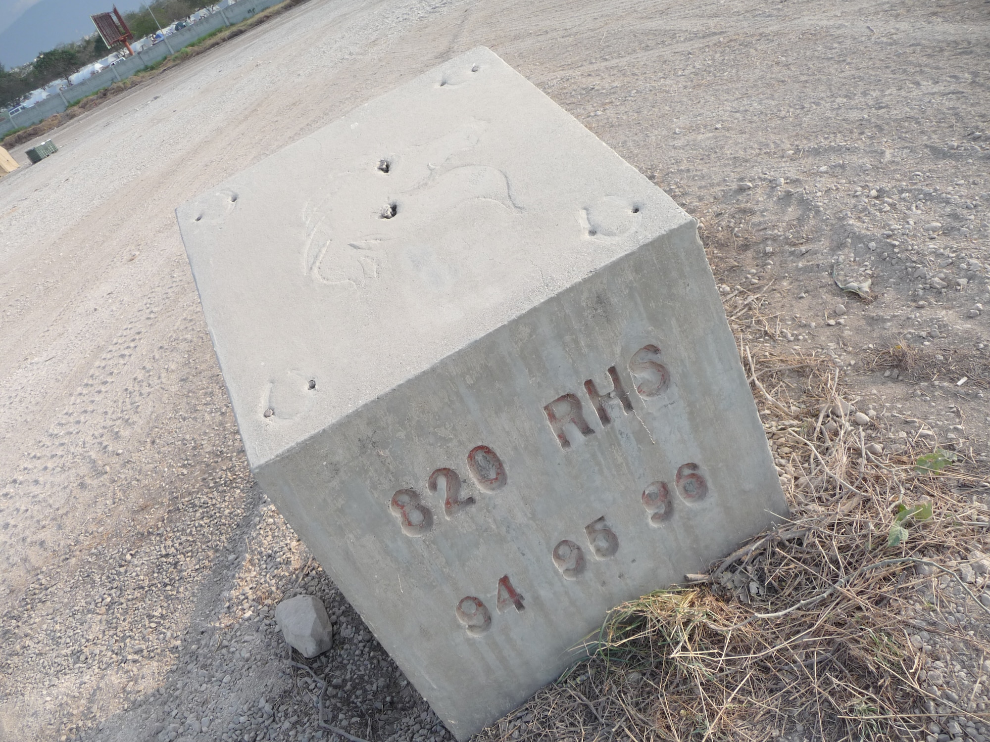 PORT-AU-PRINCE, Haiti -- A concrete block etched with "820th RED HORSE Squadron" stands near the camp of the 24th Air Expeditionary Group at Toussaint L'Ouverture International Airport. The 820th RHS spent time in Haiti in 1994, 1995, and 1996, helping the country build basic infrastructure. The 24th AEG is the Air Force group focused on helping the country recover from a massive 7.0 earthquake Jan. 12. (U.S. Air Force photo/Capt. Nathan Broshear)