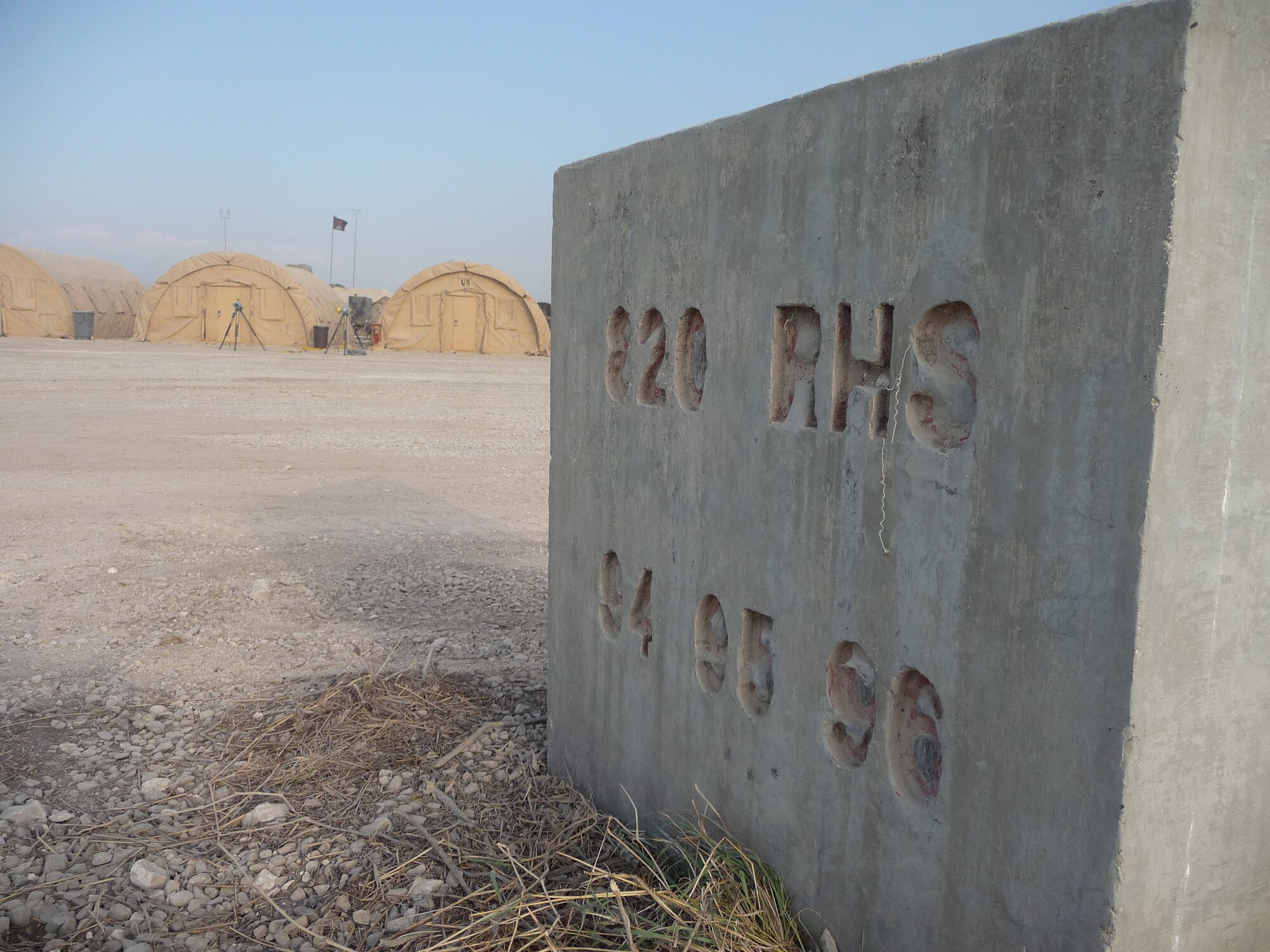 PORT-AU-PRINCE, Haiti -- A concrete block etched with "820th RED HORSE Squadron" stands near the camp of the 24th Air Expeditionary Group at Toussaint L'Ouverture International Airport. The 820th RHS spent time in Haiti in 1994, 1995, and 1996, helping the country build basic infrastructure. The 24th AEG is the Air Force group focused on helping the country recover from a massive 7.0 earthquake Jan. 12. (U.S. Air Force photo/Capt. Nathan Broshear)