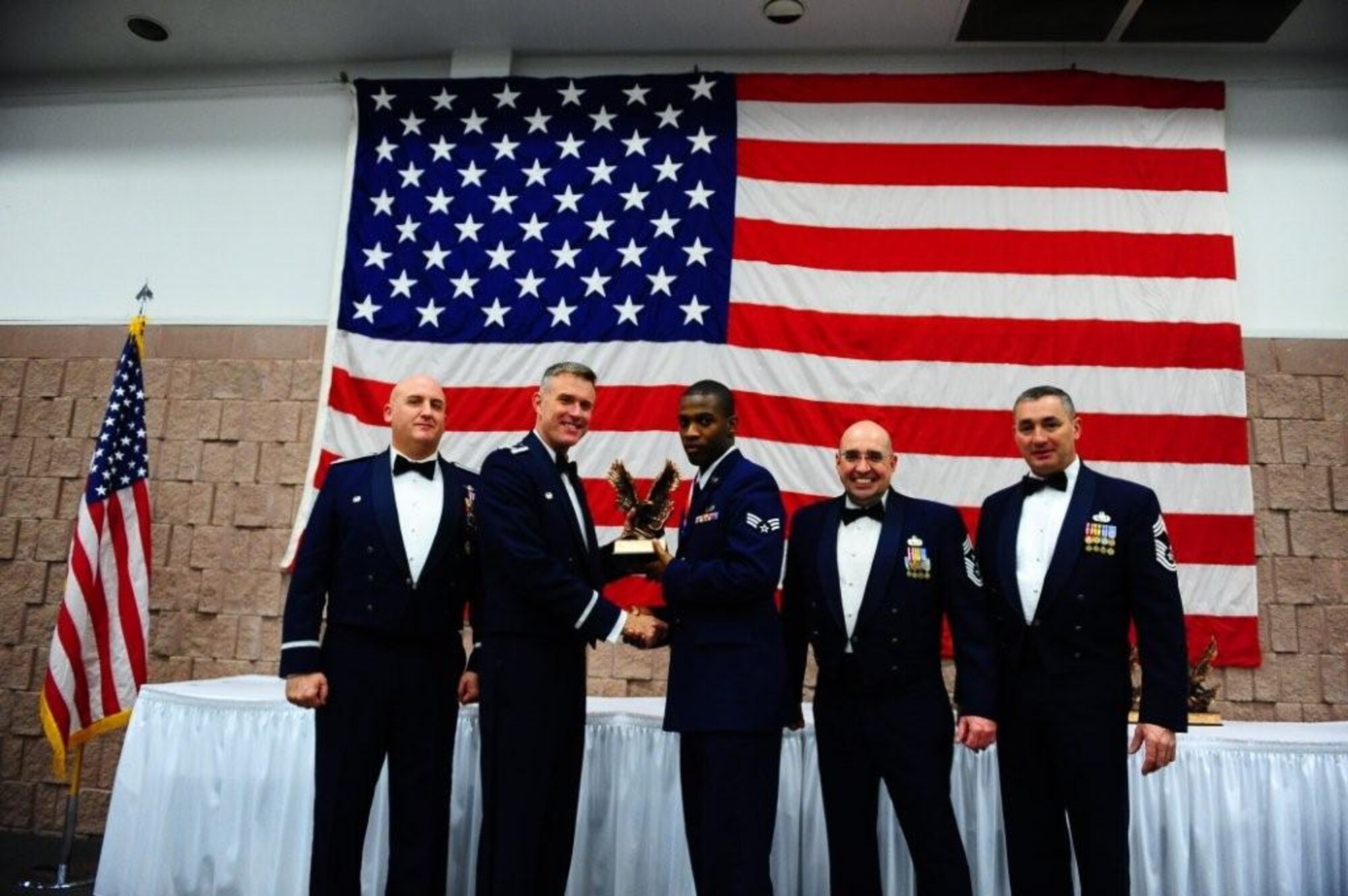 ABILENE, Texas -- Col. Robert Gass, 7th Bomb Wing Commander, presents Honor Guard Airman of the Year Award to Senior Airman Jermain Williams, 7th Force Support Squadron Feb. 12 at the Abilene Civic Center. Dyess Air Force Base held an Annual Awards Banquet to recognize the top performers of 2009. (Air Force photo by Senior Airman Stephen Reyes)