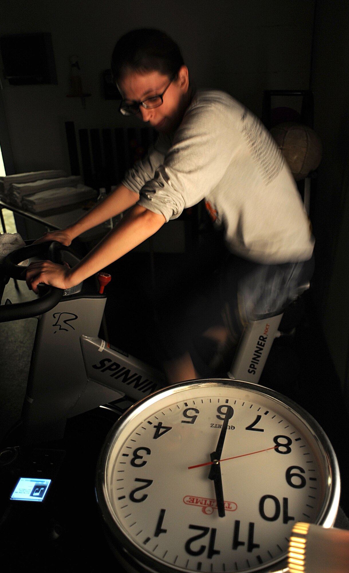 Staff Sergeant Helen Palmer, 27th Special Operations Force Support Squadron, watches the clock as she instructs the Wednesday Hump Day Spin-A-Thon class at the Cannon Air Force Base, N.M., fitness center Feb. 17.  The Spin-A-Thon is a two- hour event that tests an individual's fitness and endurance. (U.S. Air Force Photo by Senior Airman Evelyn Chavez)
