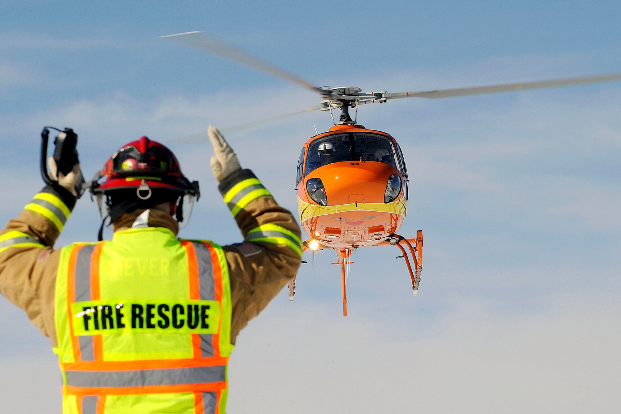 A Flight for Life helicopter is guided by a base fireman during an exercise Feb. 10, 2010, at Schriever Air Force Base, Colo. The helicopter and crew added to the realism of the exercise scenario. (U.S. Air Force photo/Dennis Rogers)