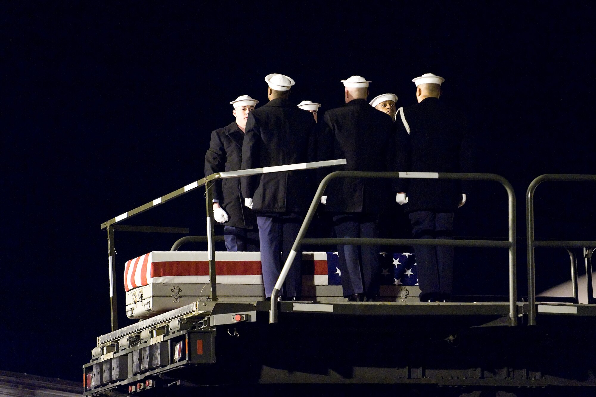 A U.S. Navy team transfers the remains of Navy Petty Officer 1st Class Sean L. Caughman, at Dover Air Force Base, Del., February 17. (U.S. Air Force photo/Roland Balik)