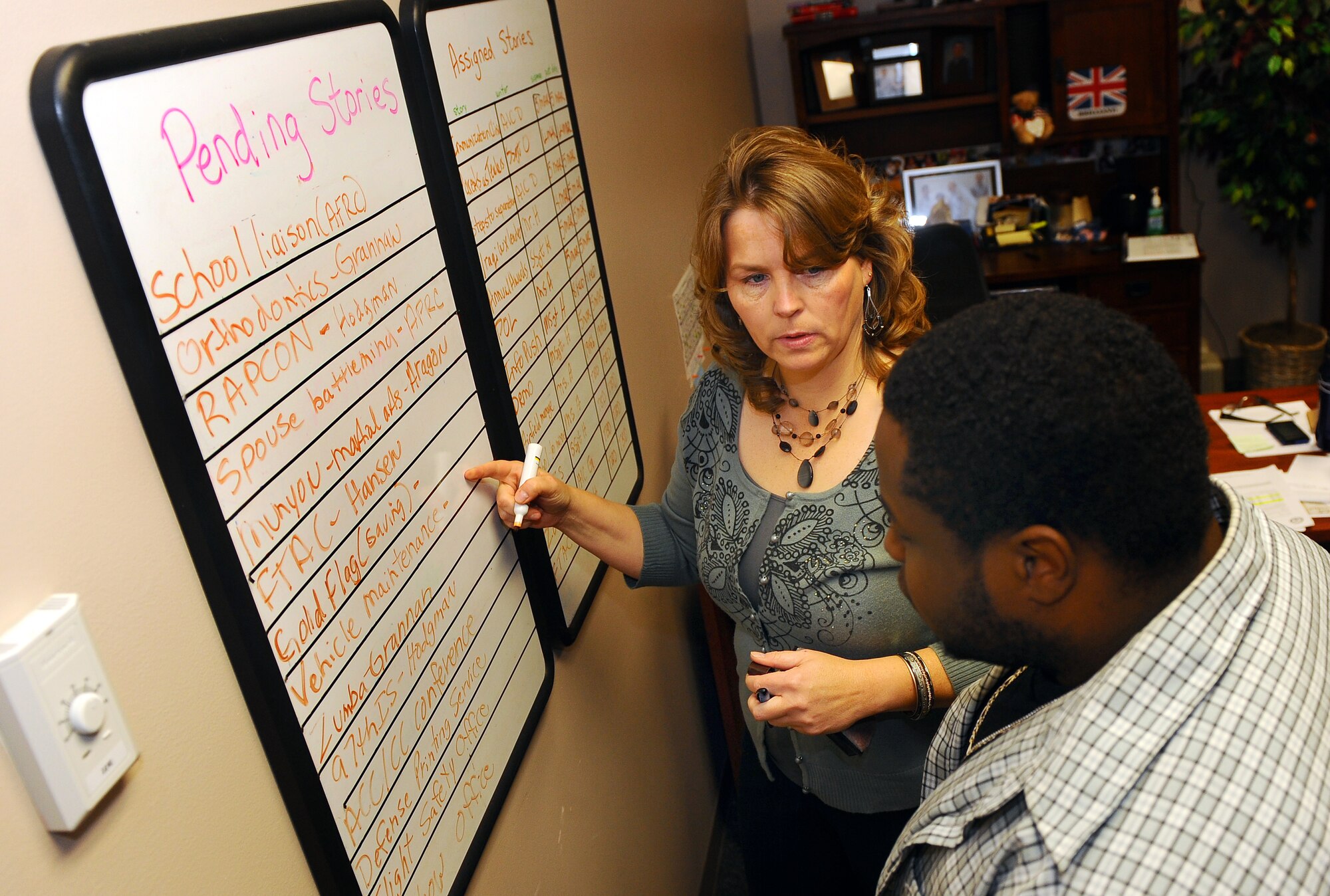 OFFUTT AIR FORCE BASE, Neb. - Deb Aragon, public affairs internal information chief, discusses upcoming articles with base photographer Charles Haymond Feb. 18.  Pending stories are planned months in advance to insure articles and accompanying photos are posted in a timely manner for multiple mediums.
U.S. Air Force photo by Josh Plueger
