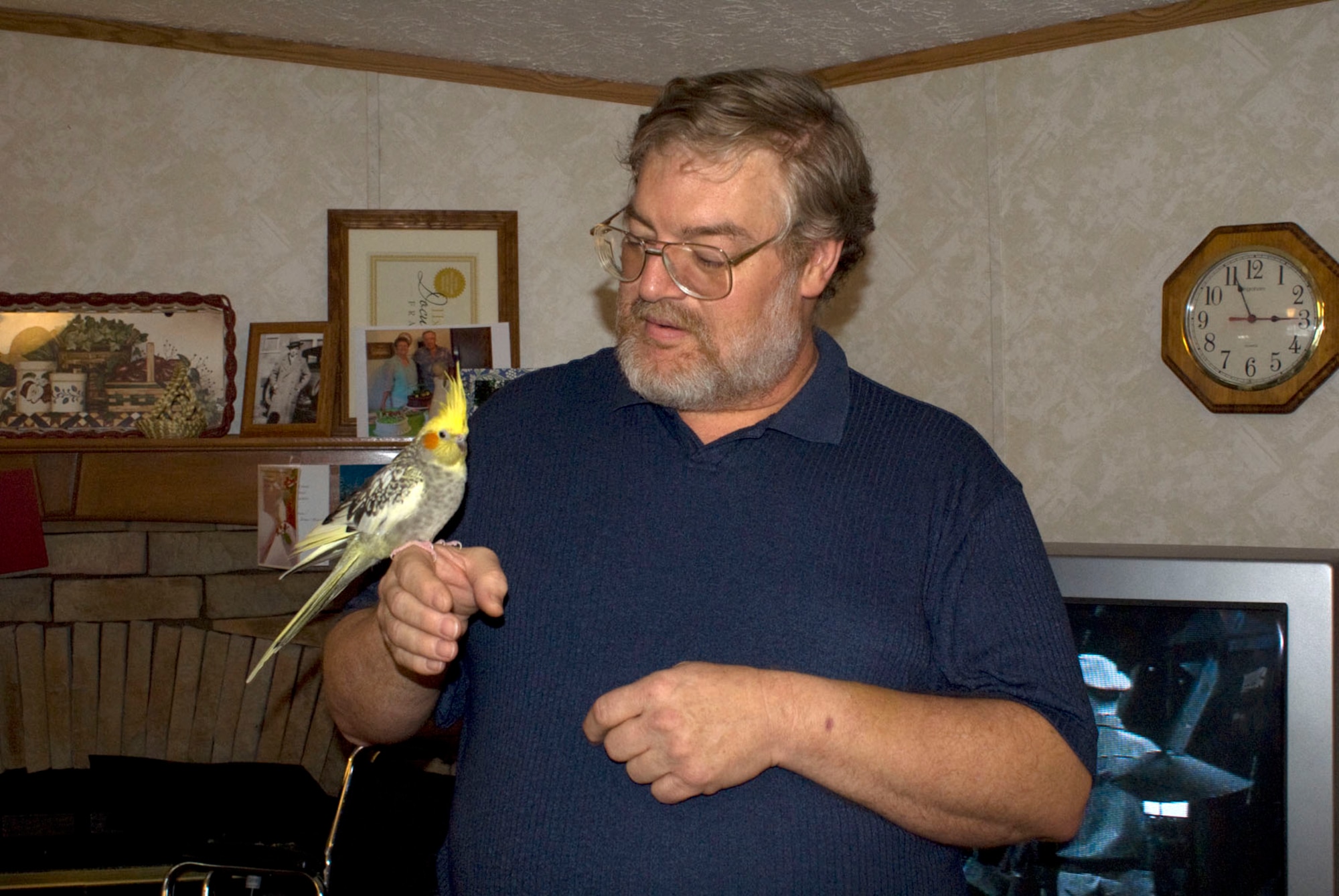 Michael Bunch survived a heart attack Feb. 11 due to the rapid response by Precision Measurement Equipment Laboratory coworkers Dale West, Gary Fergus and Brad Pearson and Arnold Air Force Base EMTs, security and the dispensary’s nurse practitioner. Bunch, holding one of his pet birds at his home in Hillsboro, says he feels good overall and should be able to return to work in a few weeks. (Photo by Philip Lorenz III)