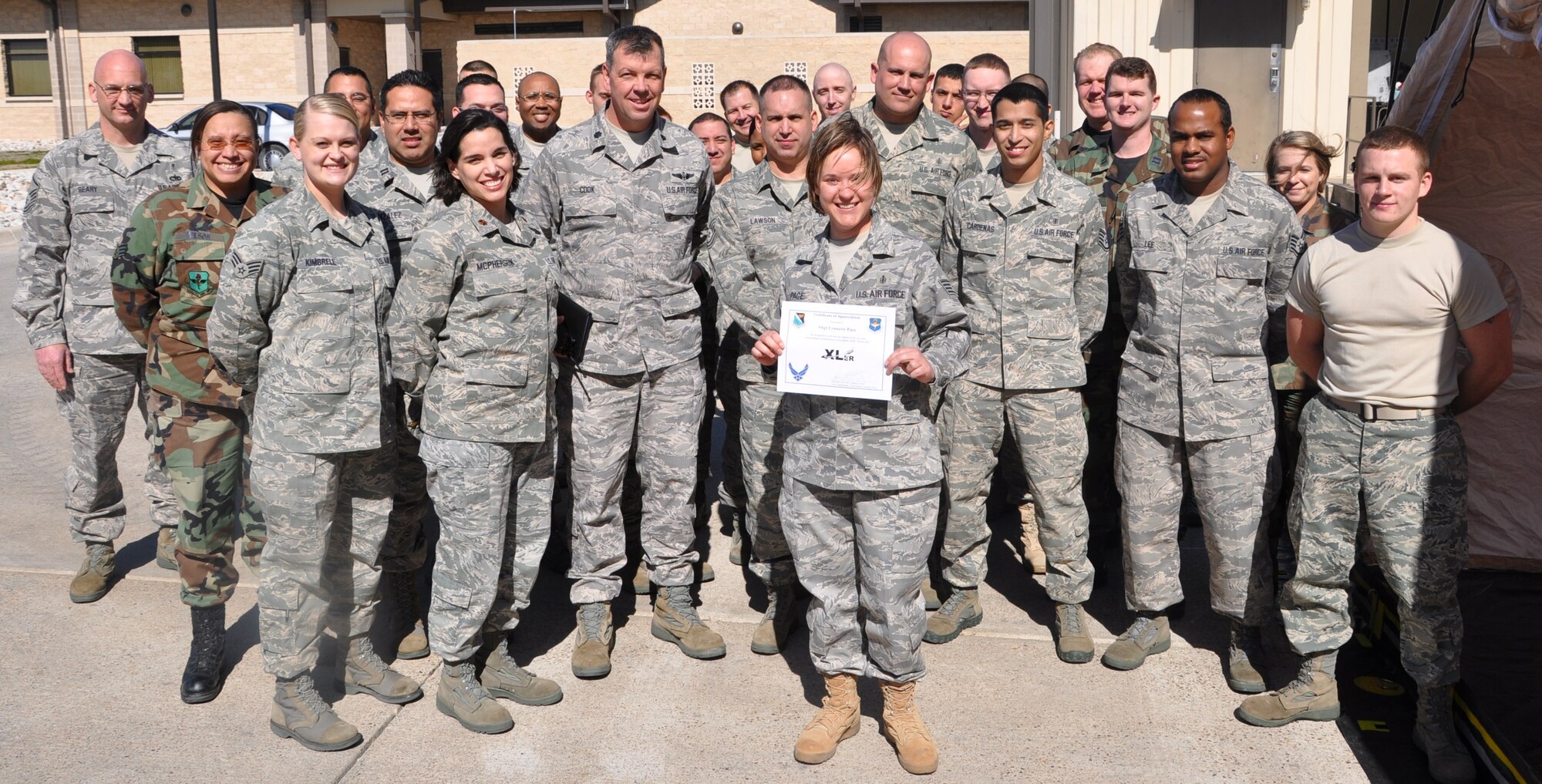 LAUGHLIN AIR FORCE BASE, Texas – Staff Sgt. Lynnette Pace, 47th Medical Operations Squadron, poses with fellow members of her squadron after being presented the XLer of the Week award by Col. David Ellis, 47th Flying Training Wing vice commander, here Feb. 17. Sergeant Pace has been in the Air Force for more than nine years and at Laughlin for six months. (U.S. Air Force photo by Airman 1st Class Blake Mize)