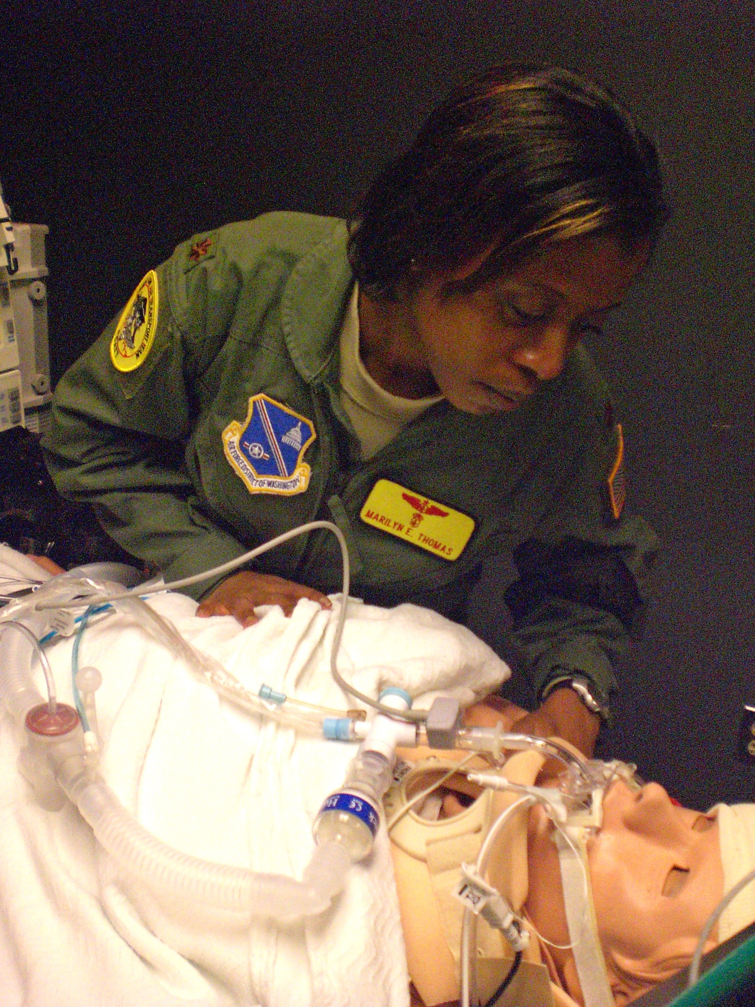 Maj. Marilyn Thomas, a critical care nurse from Andrews Air Force Base, Md., looks at one of the human patient simulator manikins inside the Air Force's CSTARS Feb. 12, 2010, at University Hospital Cincinnati in Cincinnati, Ohio. Major Thomas, already a flight nurse for aeromedical evacuation missions, is training to become a critical care air transport team member. CSTARS Cincinnati trains CCATT members and evaluates their readiness to fly missions downrange. (U.S. Air Force photo/Derek Kaufman) 